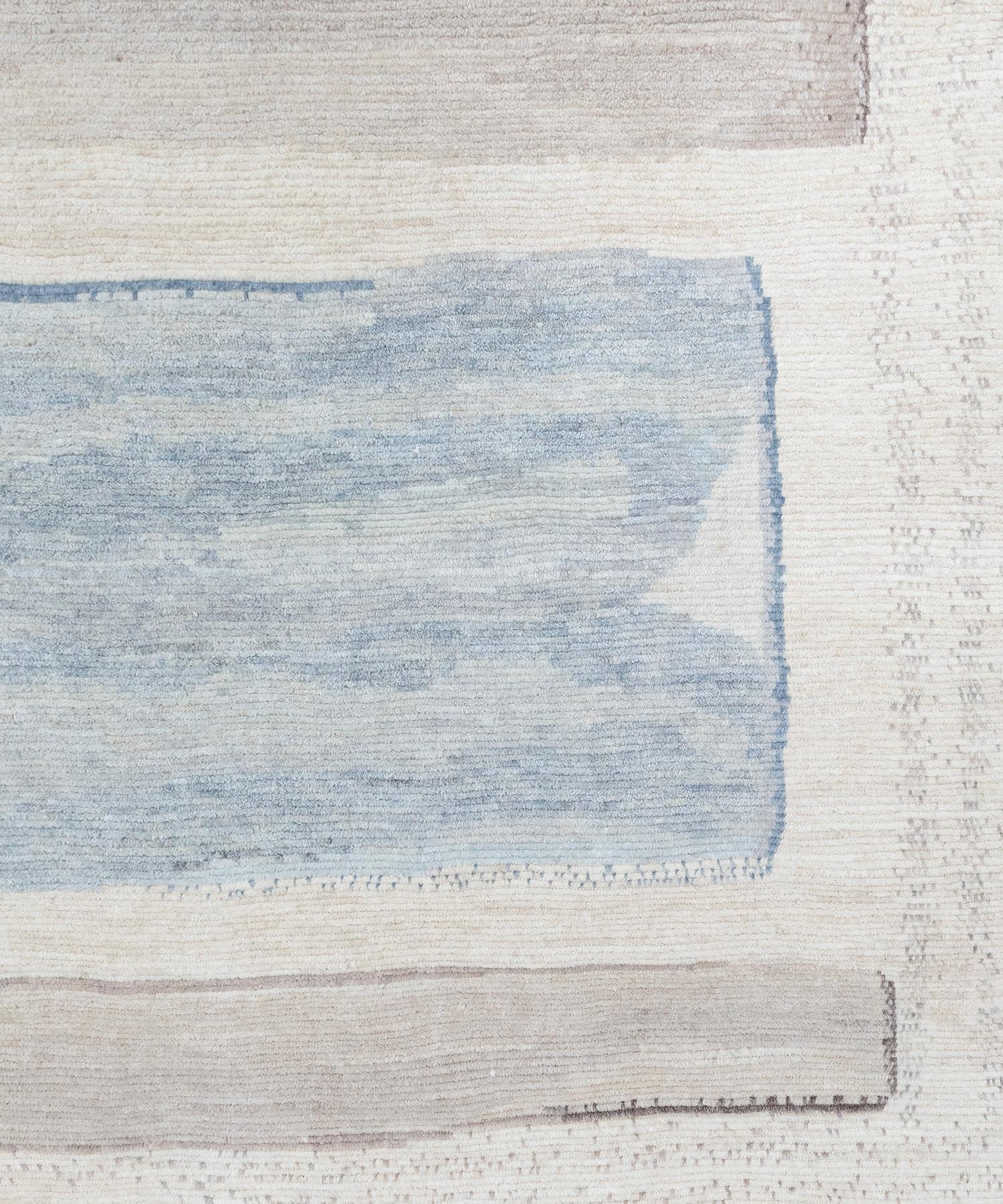 Our Nevis rug is handknotted using the finest quality hand-spun wool and natural dyes. This minimalist and modern design blends neutral beige and ivory tones with a pop of cool blues. Custom sizes and colors available.

