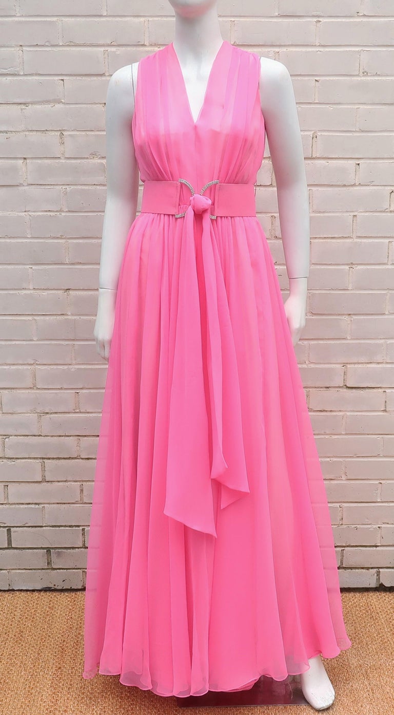 1960's Nat Kaplan hot pink chiffon evening dress with a rhinestone embellished belt.  The lovely design has an ethereal quality and is reminiscent of a goddess gown silhouette. The transparent hot pink chiffon is layered over a pale pink crepe