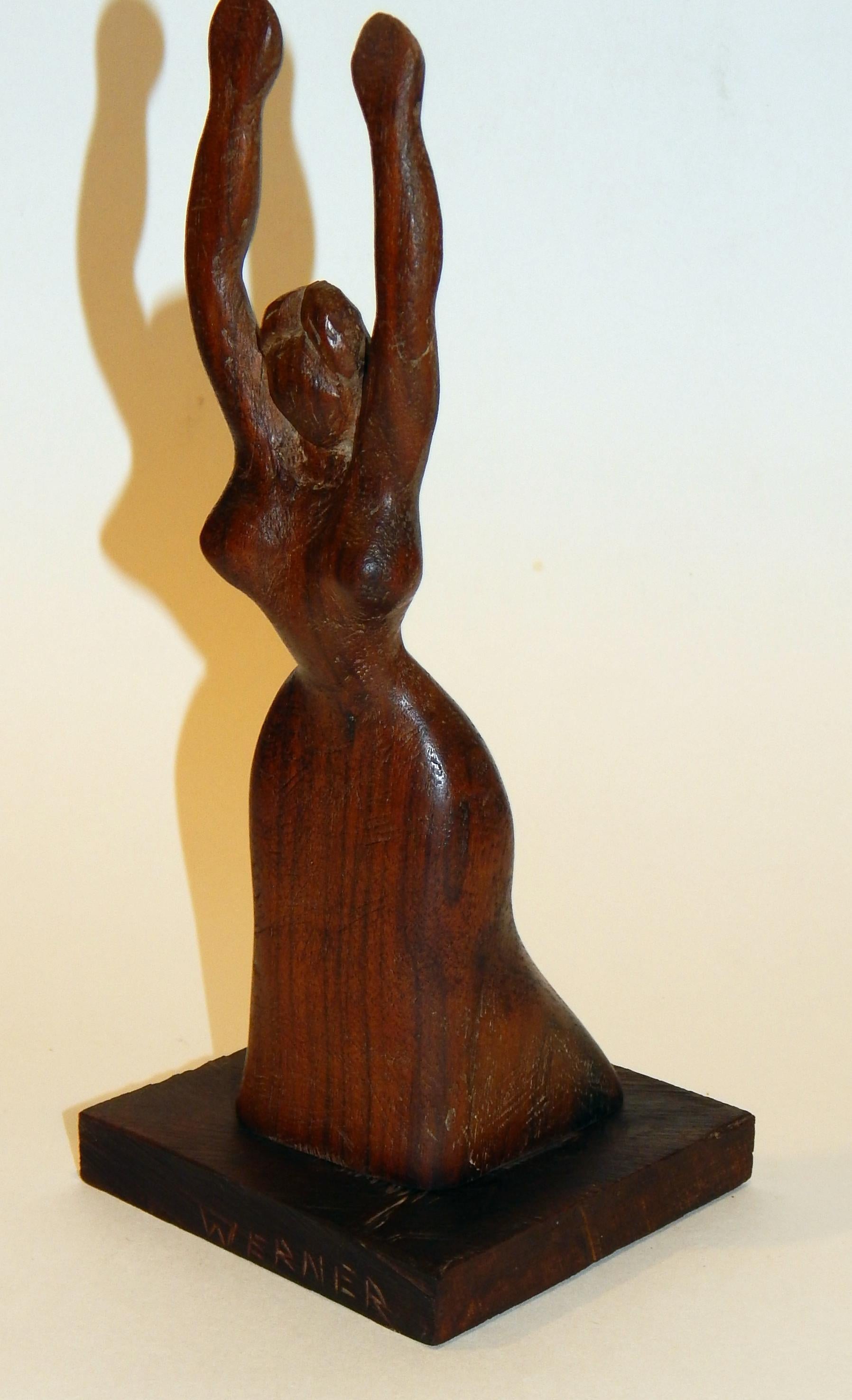 Wood sculpture by Nat Werner of a woman with arms outstretched.
Measures 10