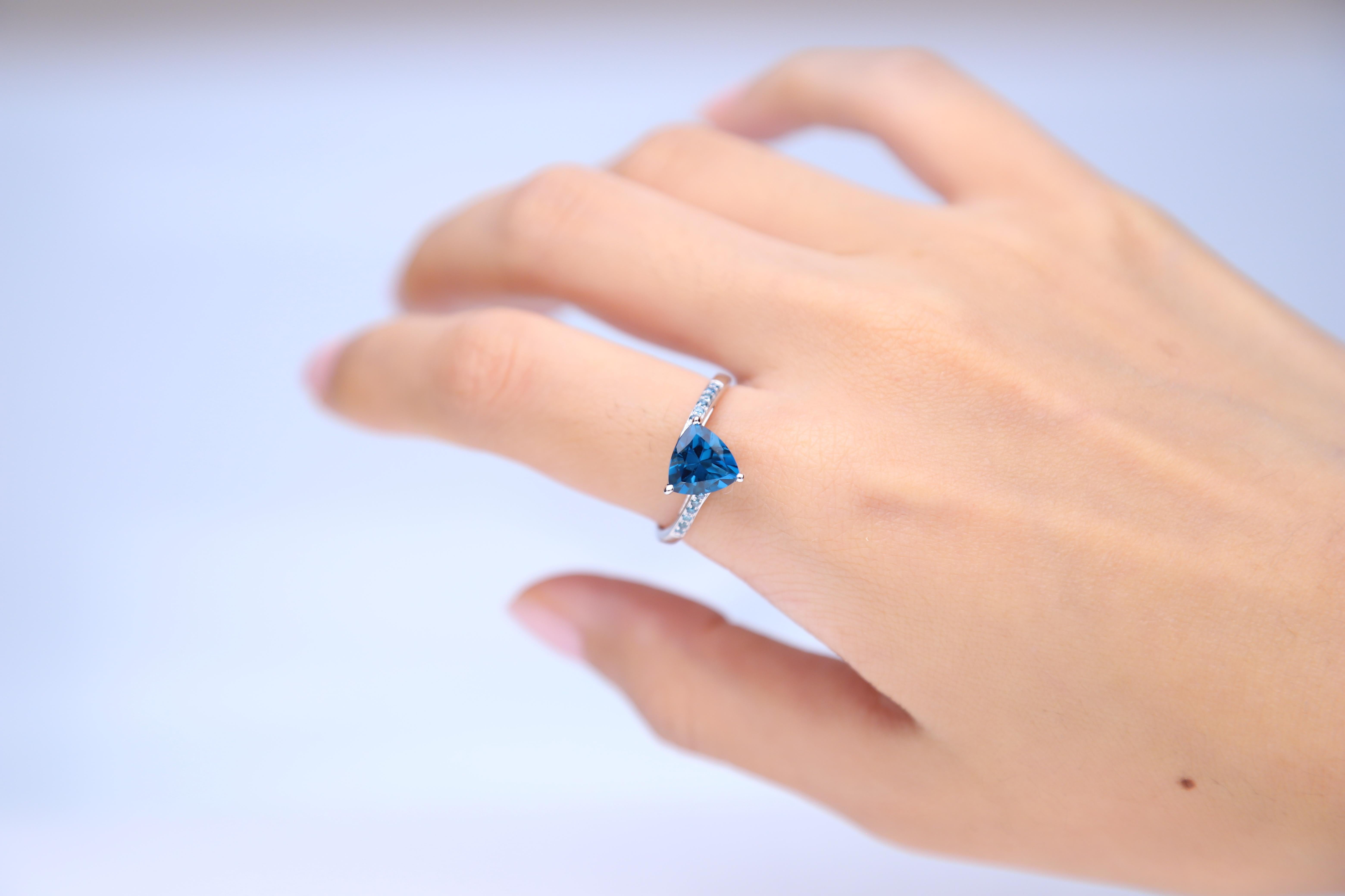 Decorate yourself in luxury with this The Loupe Club ring. The jewelry boasts trillion-cut London blue topaz and diamond accent stones for a lovely design. Gemstone colors: Blue Gemstone shapes: Trillion-cut One prong-set trillion-cut london blue