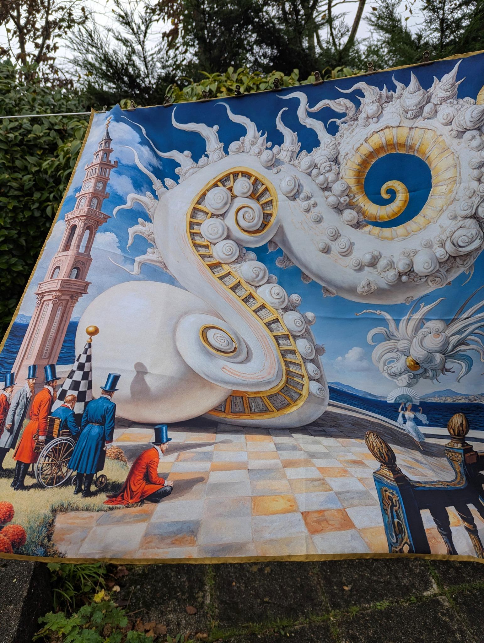 Balcony is a surrealist silk artwork where architecture, dream logic, and human emotion merge into a single theatrical tableau. A monumental spiral structure—part shell, part celestial mechanism—unfolds across an open seaside balcony. Its polished