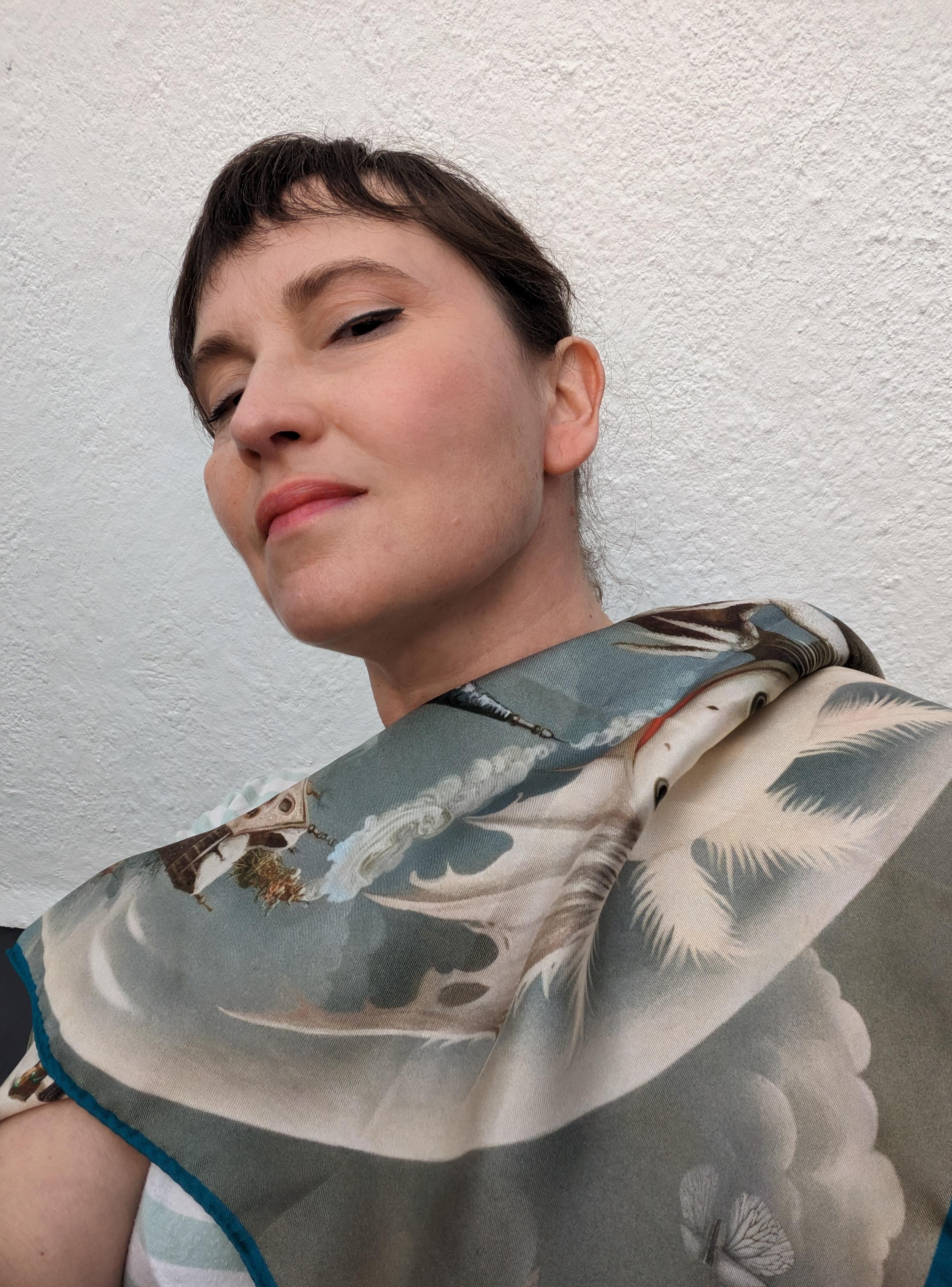 The artwork is print on silk and it is limited edition.

You posted signs, the news did spread,
The pet axolotl, from its tank, it fled.
Look to the ridge, above the town's bowers,
Is that our friend, amidst the towers?

Fragility, created for the