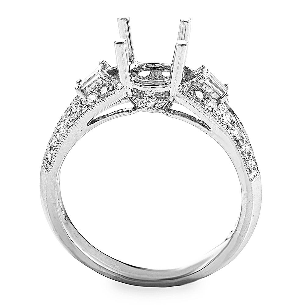 This engagement ring mounting from Natalie K is simple and sophisticated. It is made of 18K white gold and boasts shanks set with ~.41ct of diamonds.
