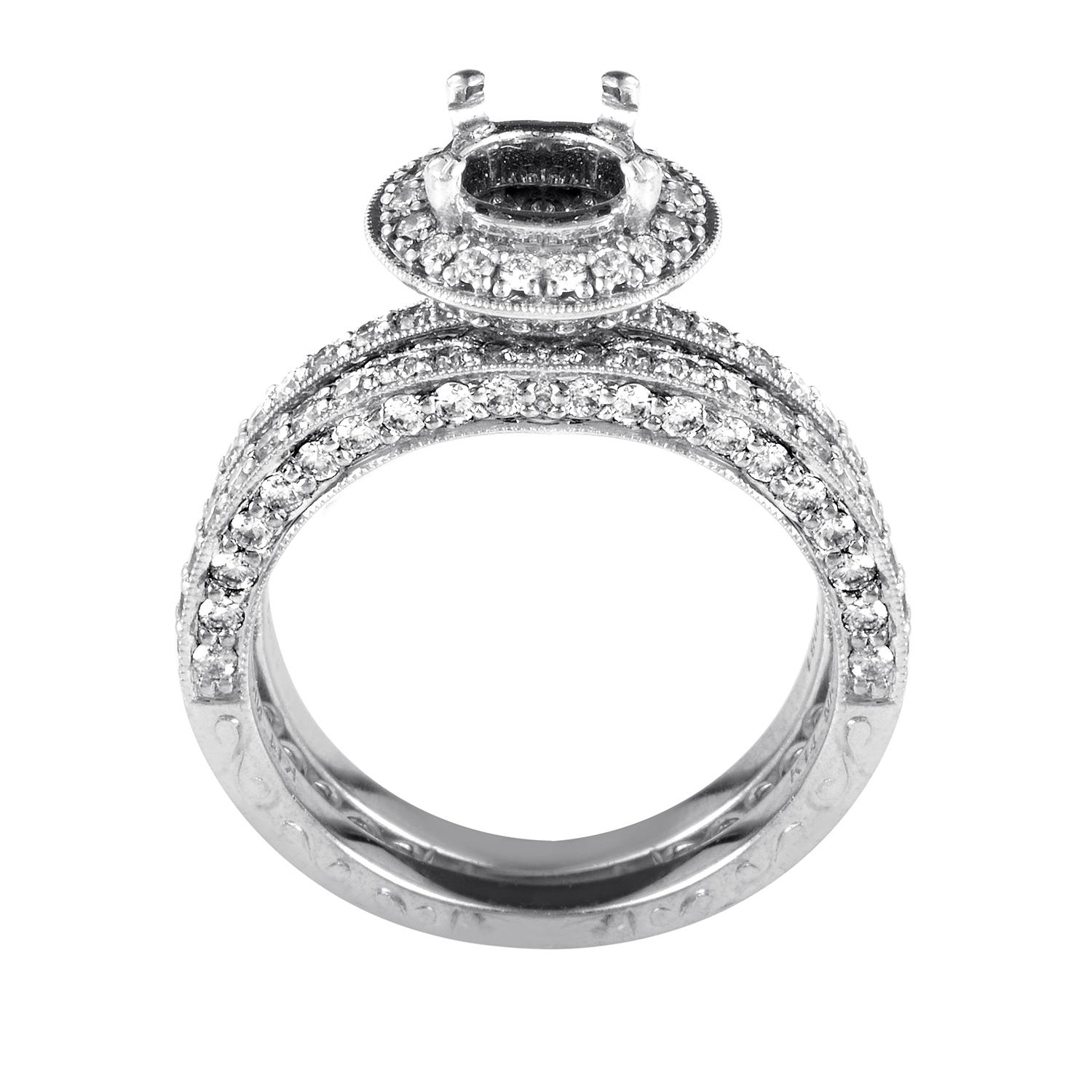 A heavenly semi mount bridal set by Natalie K in 14K white gold dazzles with pave set diamonds along the front and sides, as well as along the halo that surrounds the 4 prong center setting, totaling 1.37ct. Both bands measure 4mm when laying flush