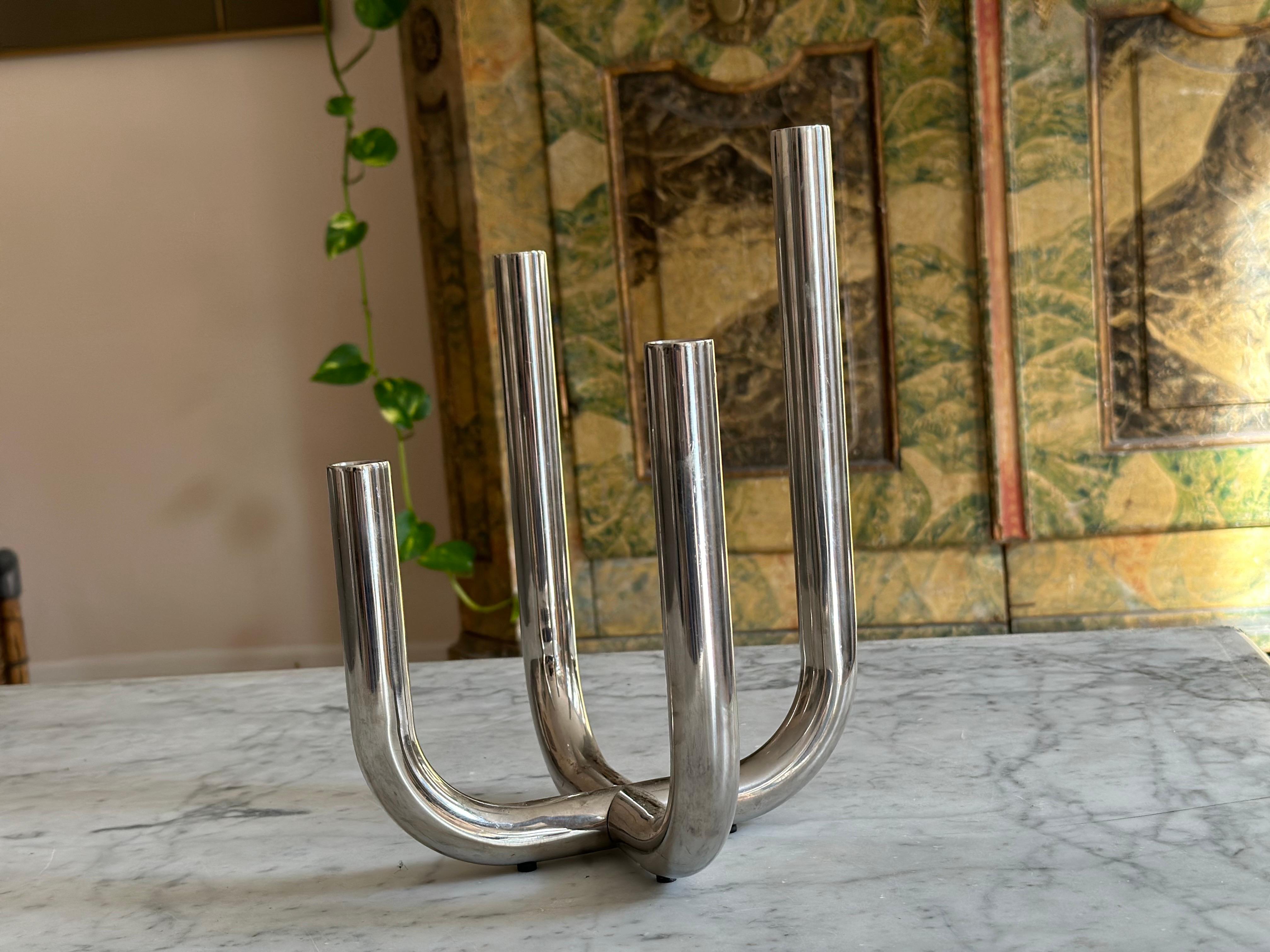 This stunning, clear four-arm candle holder, designed by German designer Natalie Rutard and crafted by Philippi GmbH, exemplifies modern elegance in polished stainless steel. No longer in production, this rare candelabrum combines functionality with