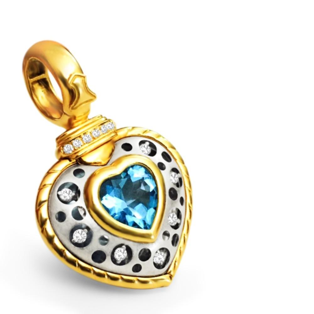 Metal: 18k yellow and white gold. Two tone gold. 

Diamonds: 0.24 carat total. VVS Clarity and F color. 

Center stone: Blue Topaz, heart shaped. 

Signature piece by Natasha C. Modern piece with a retro finish and look. 

Ladies fine jewelry