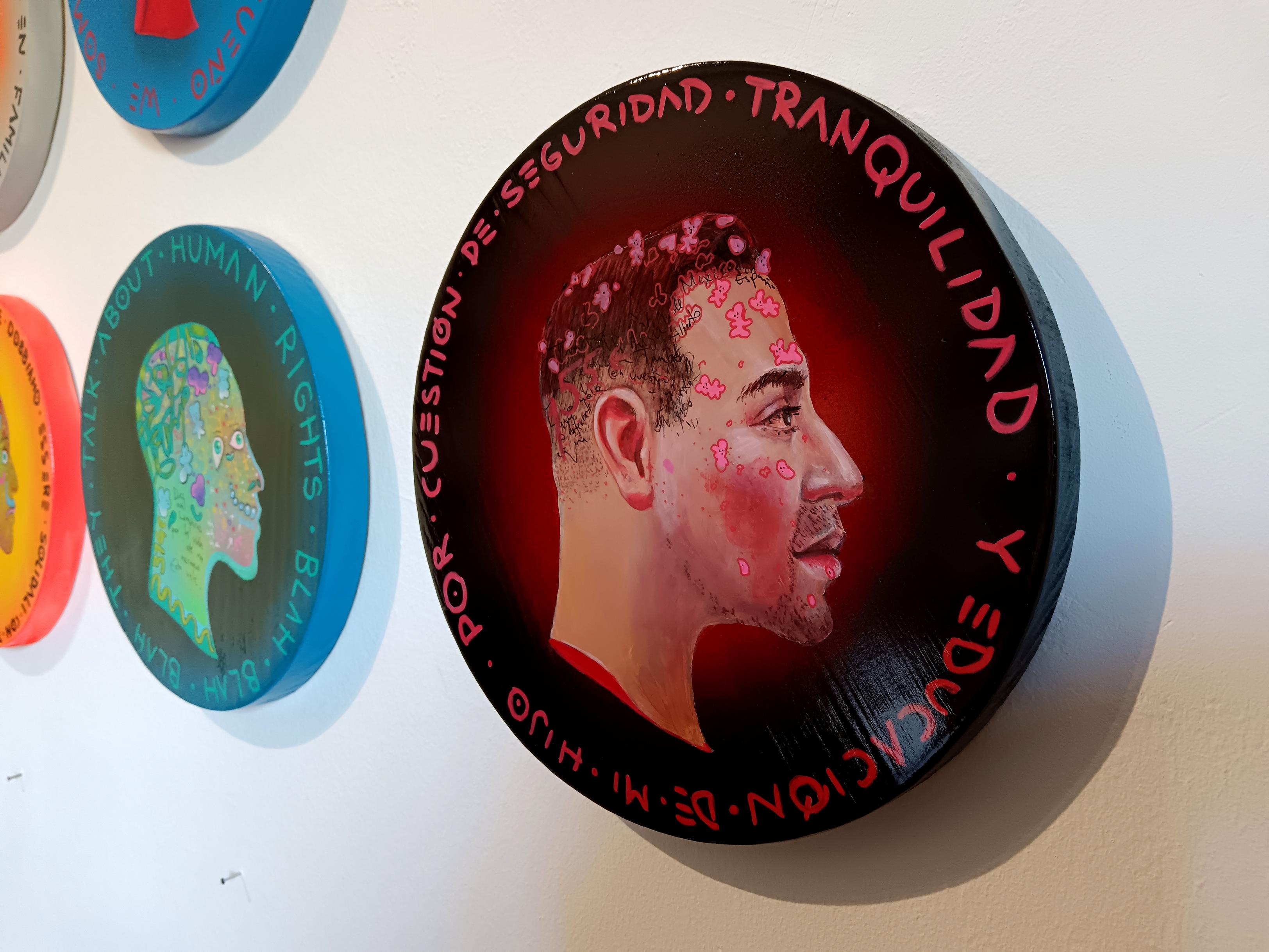 This artwork, crafted in acrylic and mixed media on wood in the shape of a coin face, belongs to Natasha Lelenco's 