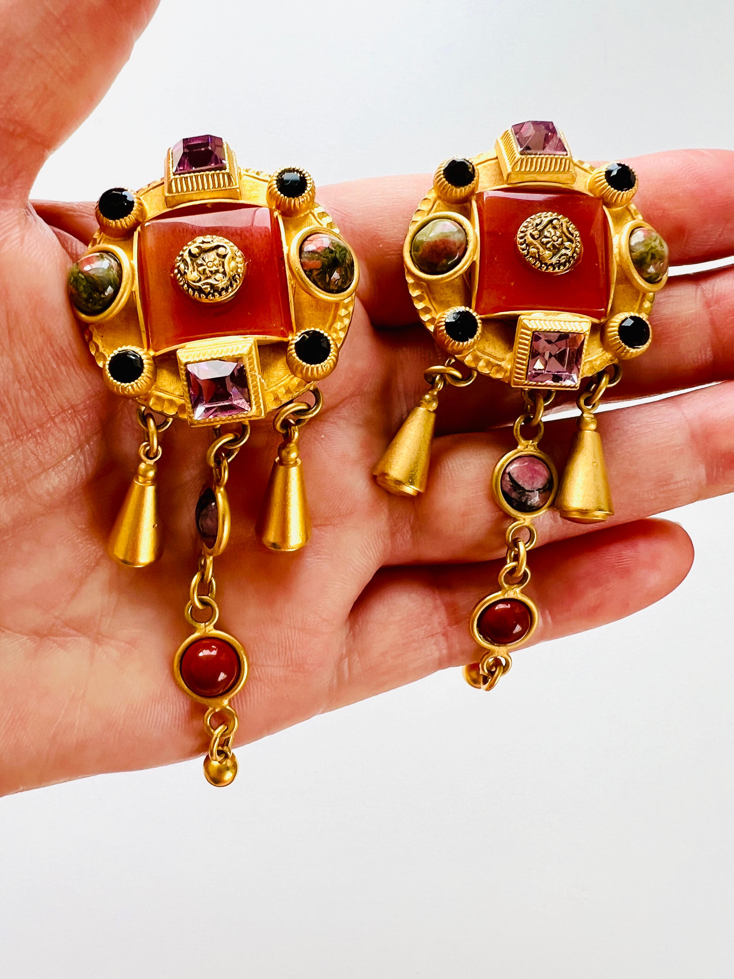 These stunning earrings by Natasha Stambouli showcase a haute couture Etruscan revival style design, adorned with semi-precious stones in vibrant multicolor hues. The earrings feature eleven stones, including Agate and Jasper Chalcedony cabochons