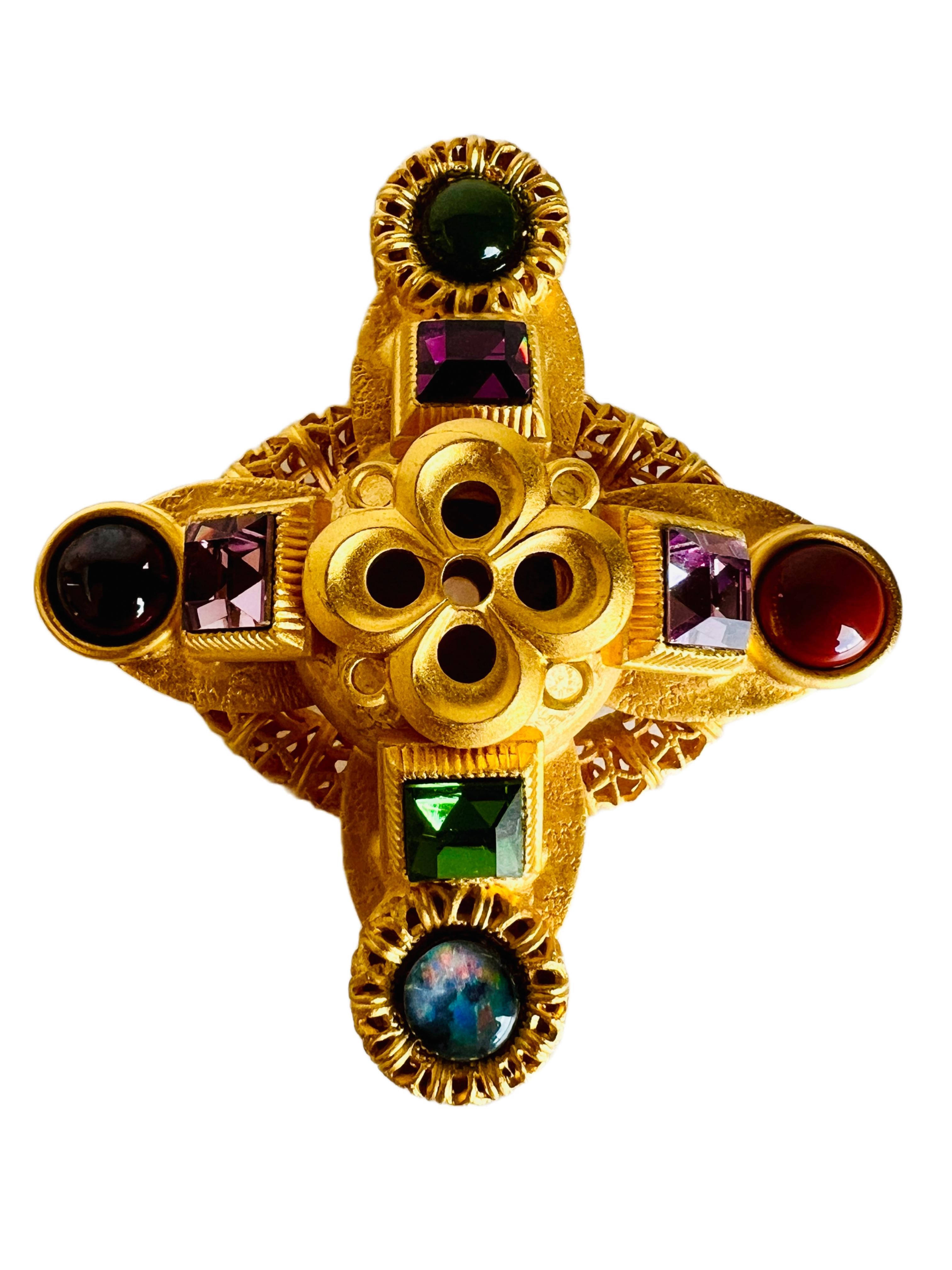 This exquisite brooch pin by Natasha Stambouli showcases a haute couture Etruscan revival style cross design, adorned with semi-precious stones in vibrant multicolor hues. The piece features eight stones, including 2 varieties of Chalcedony, a