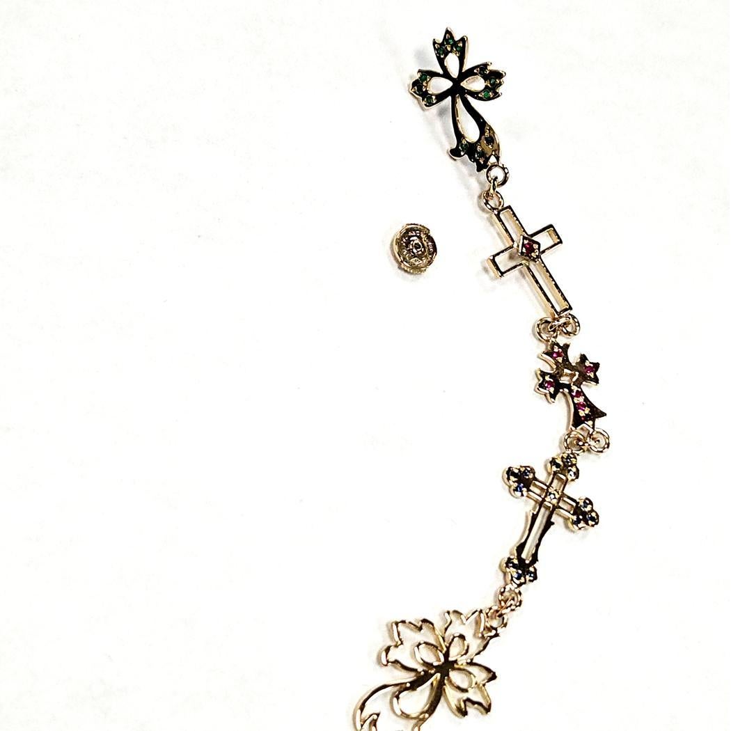 Exceptional and rare Natasha Zinko single statement earring crafted in solid 18K yellow gold, featuring five different cross designs linked in a dramatic, elongated drop. This bold, collectible piece showcases Natasha Zinko’s signature blend of