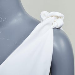 NATASHA ZINKO top oversize svasato con scollo a V, spalline annodate in cotone e orlo asimmetrico, FR34 XS