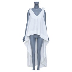 NATASHA ZINKO top oversize svasato con scollo a V, spalline annodate in cotone e orlo asimmetrico, FR34 XS