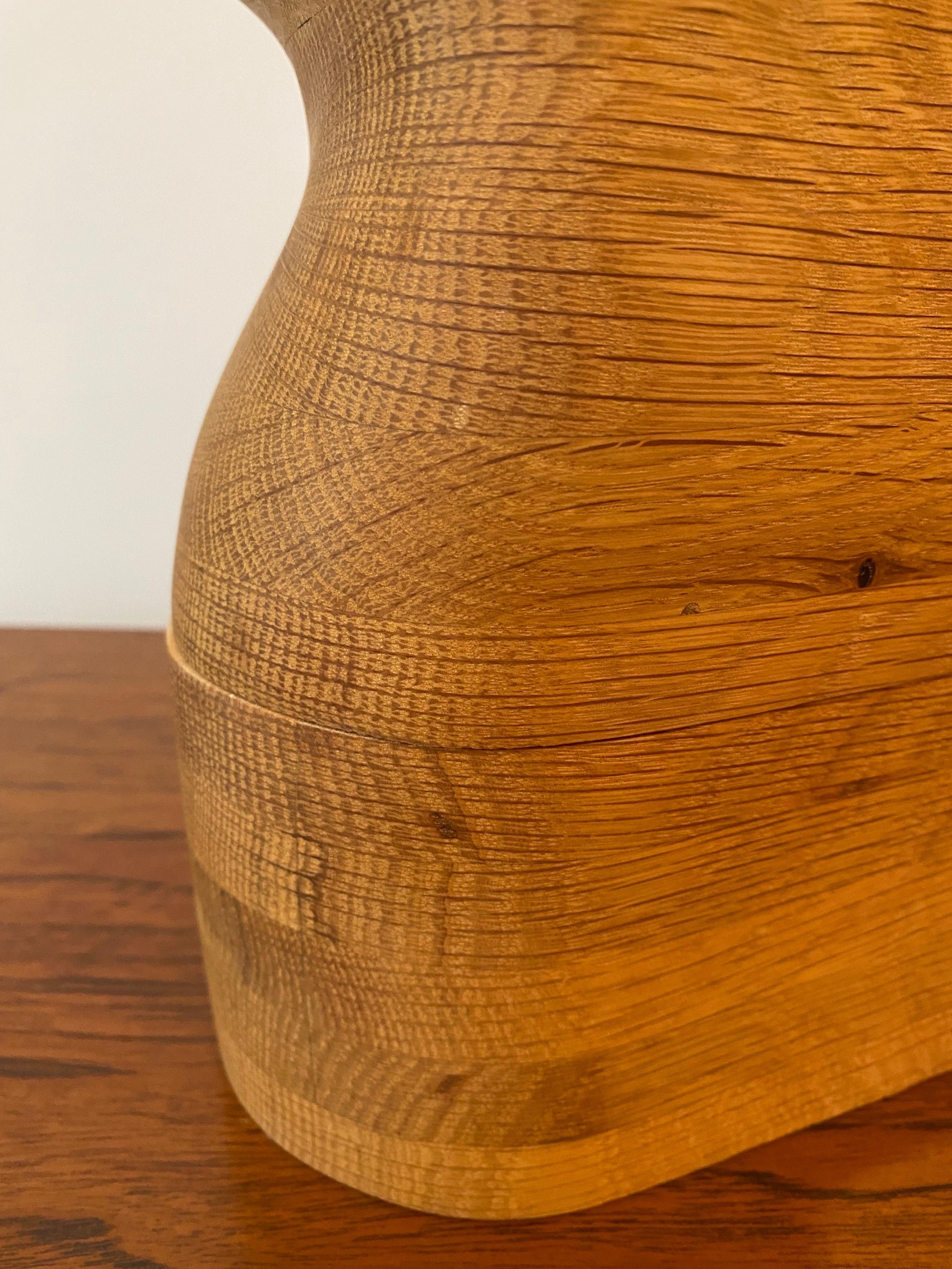 The beauty of this box sculpture is its affinity to the geological formations of the Badlands in South Dakota. In their form you can see the deposition (accumulation) of the oak wood grain and the erosion (sanding) of its surface. It opens and can