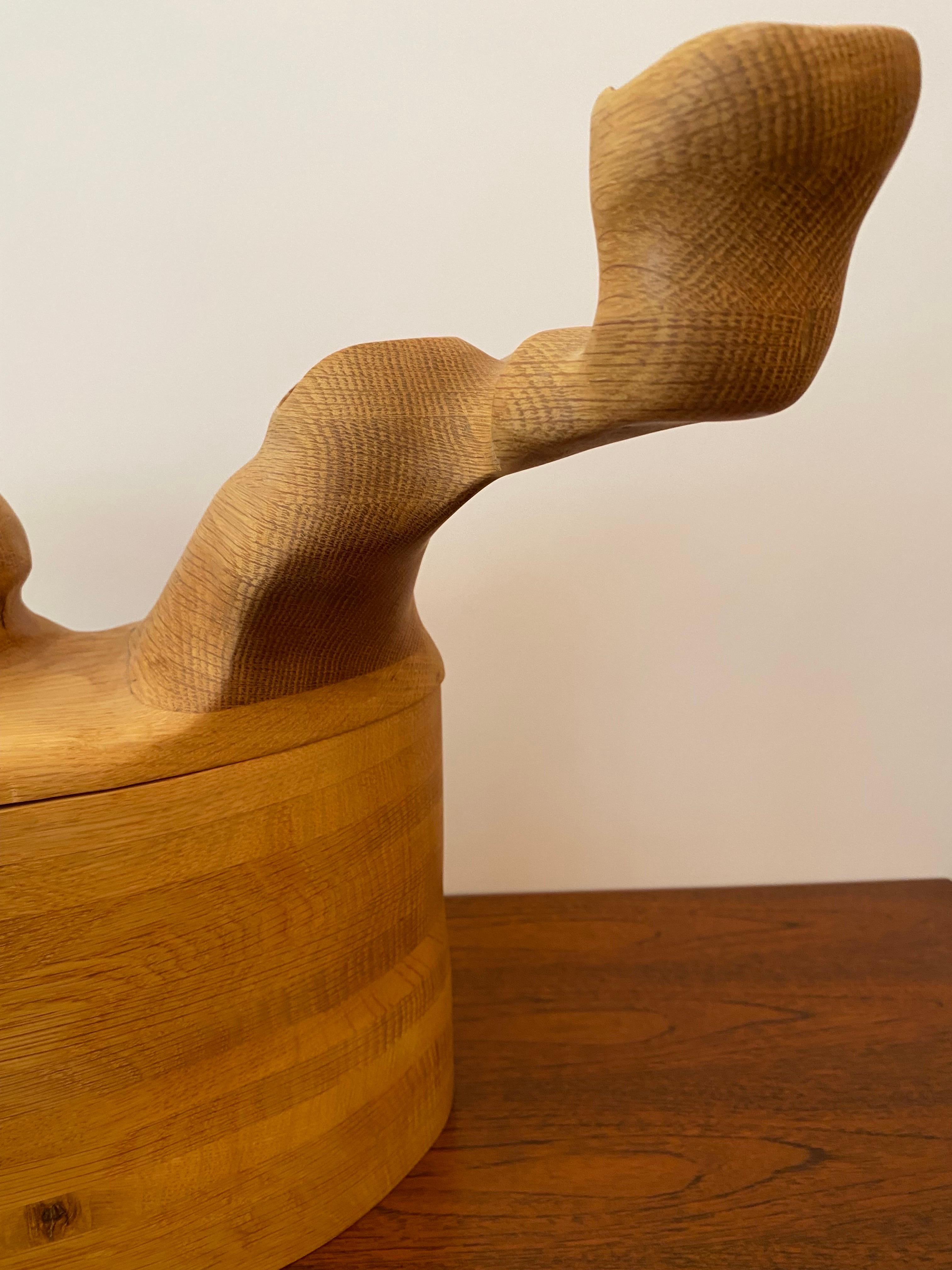 The beauty of this box sculpture is its affinity to the geological formations of the Badlands in South Dakota. In their form you can see the deposition (accumulation) of the oak wood grain and the erosion (sanding) of its surface. It opens and can