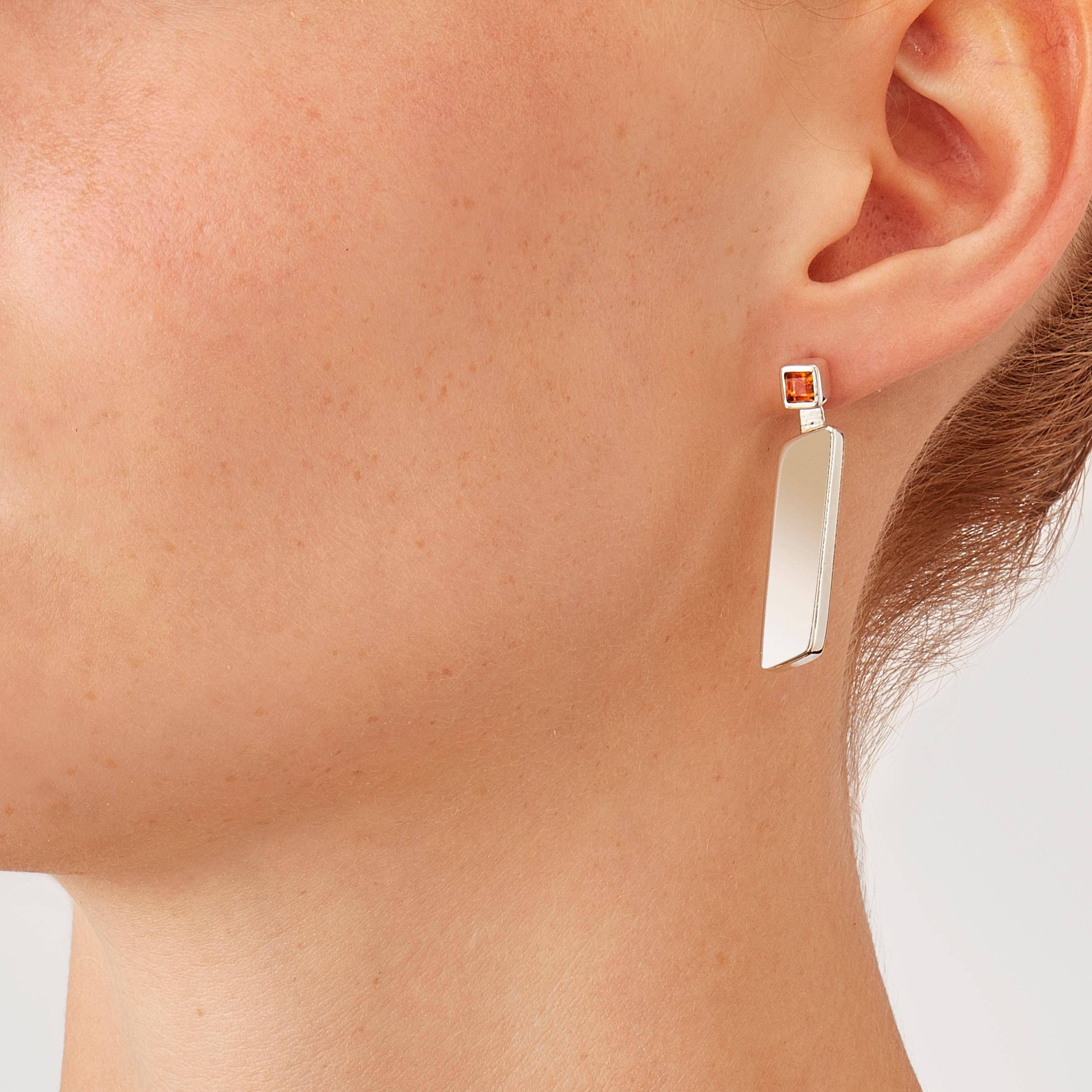 Made by hand in Nathalie Jean's Milan atelier in limited edition, the Saphir Absolu drop Earrings are composed of light hollow geometric volumes with rounded edges, in sterling silver and citrine quartz. Clever hidden links allow the pieces to