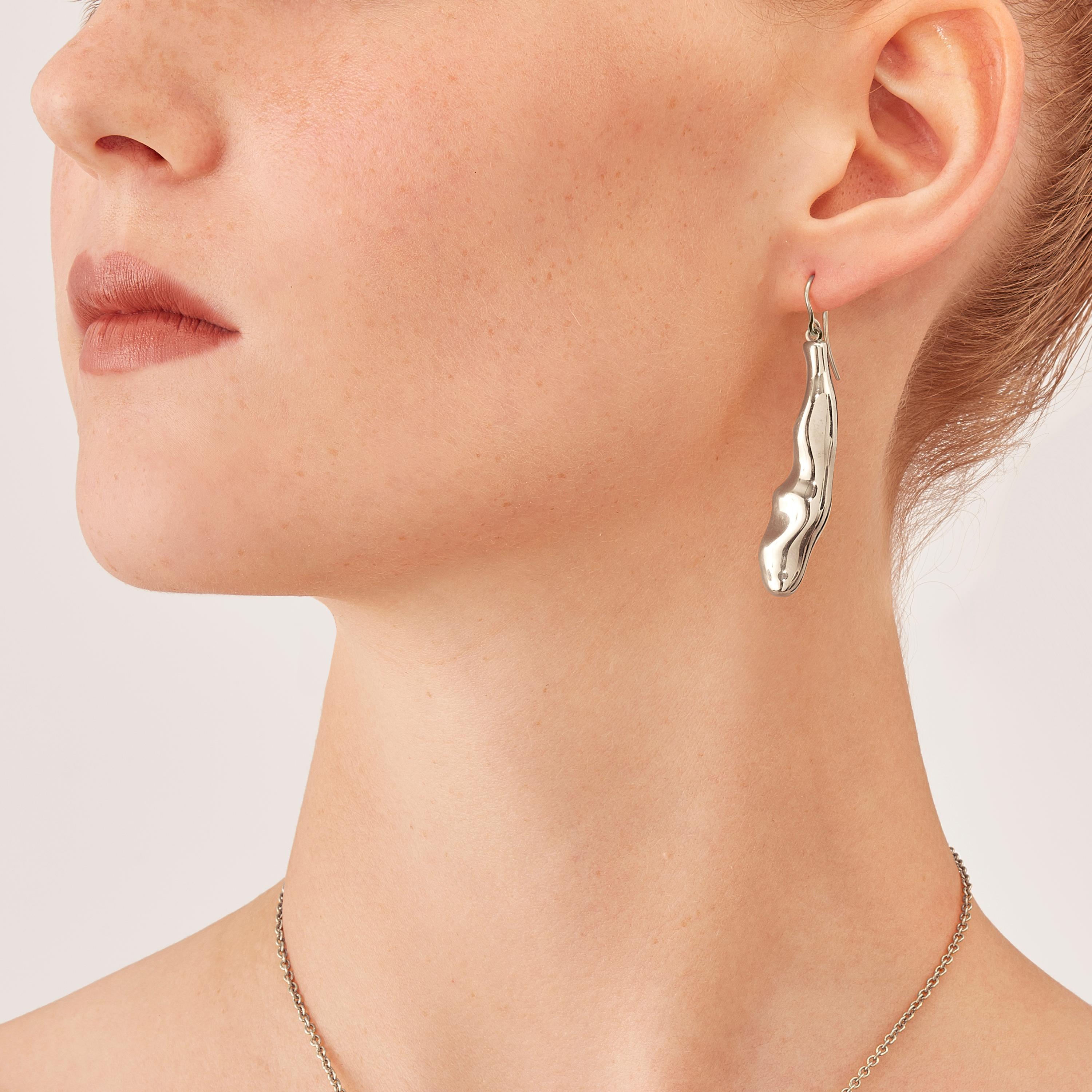 Made by hand in Nathalie Jean's Milan atelier in limited edition, Mercure Contemporary Drop Dangle Earrings are in rhodium plated sterling silver. Small, delicate, ebbing sculptures with seemingly random forms, these supple shapes are modulated in