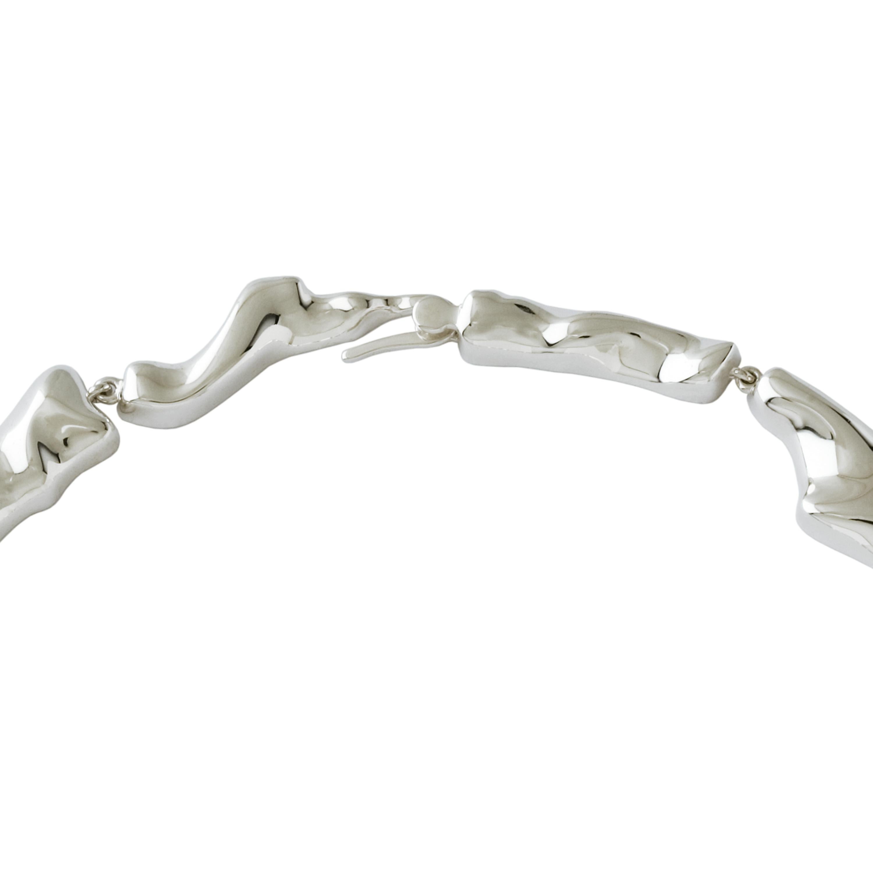 Made by hand in Nathalie Jean's Milan atelier in limited edition, the Mercure Choker Necklace is composed of 11 elements of varying dimensions in rhodium plated sterling silver. Clever hidden links allow the pieces to drape nicely around the neck.