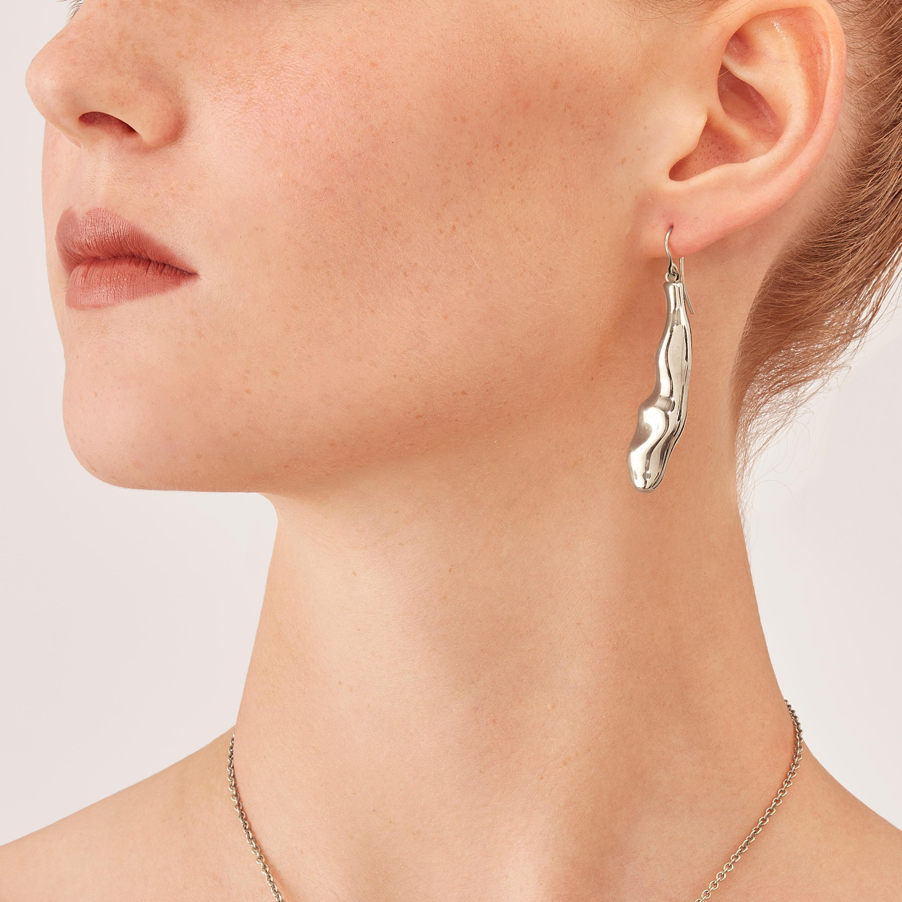 Made by hand in Nathalie Jean's Milan atelier in limited edition, Mercure Contemporary Drop Dangle Earrings are in rhodium plated sterling silver. Small, delicate, ebbing sculptures with seemingly random forms, blending contemporary and modernist