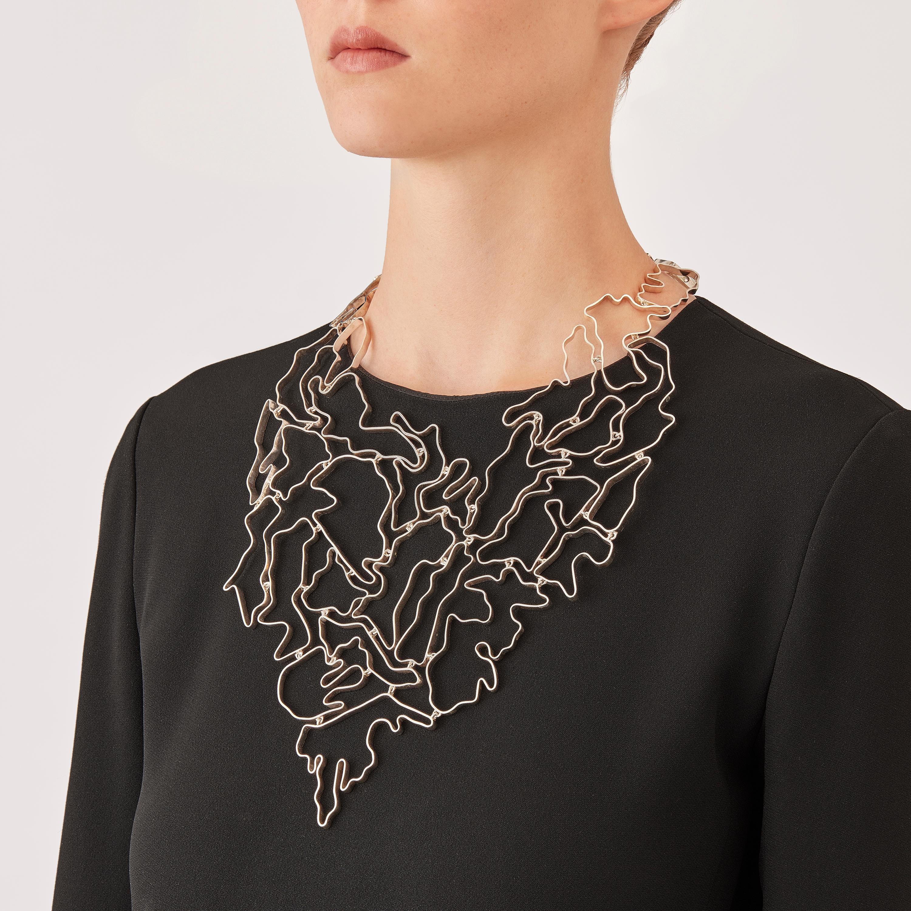 Made by hand in Nathalie Jean's Milan atelier in limited edition, the contemporary Informe Pectoral Necklace is composed of elements of varying dimensions in polished sterling silver ribbon. It's little connecting links allow the piece to drop on