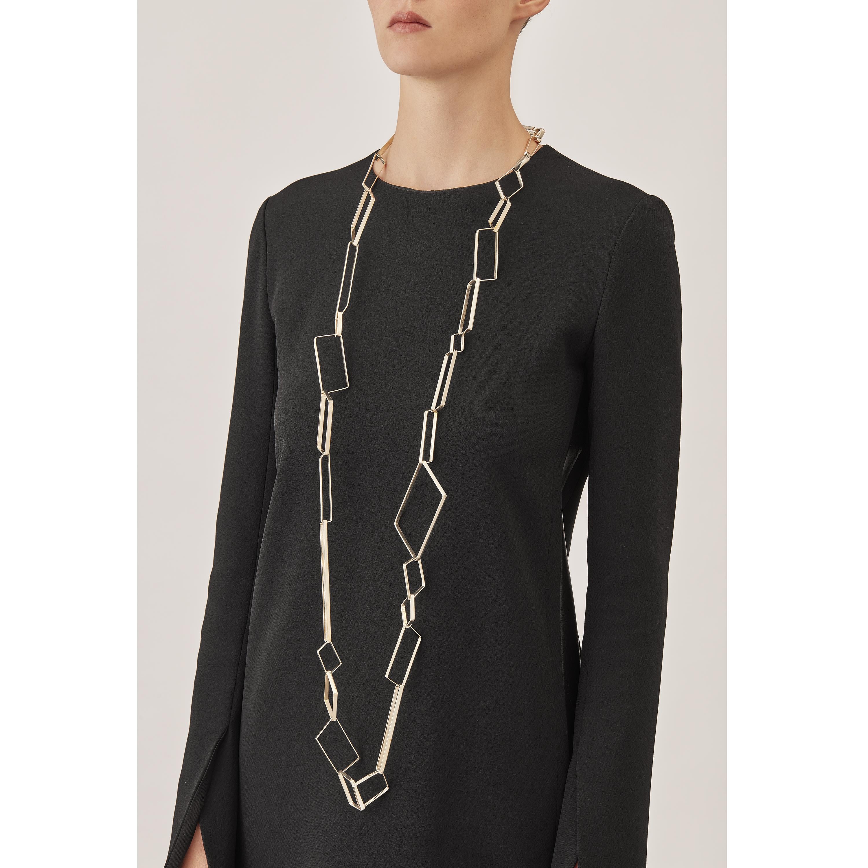 Made by hand in Nathalie Jean's Milan atelier in limited edition, Saphir Infini Long Chain is a contemporary link necklace composed of 34 sterling silver ribbon shapes with rounded edges. The angular configurations of the sapphire’s crystalline