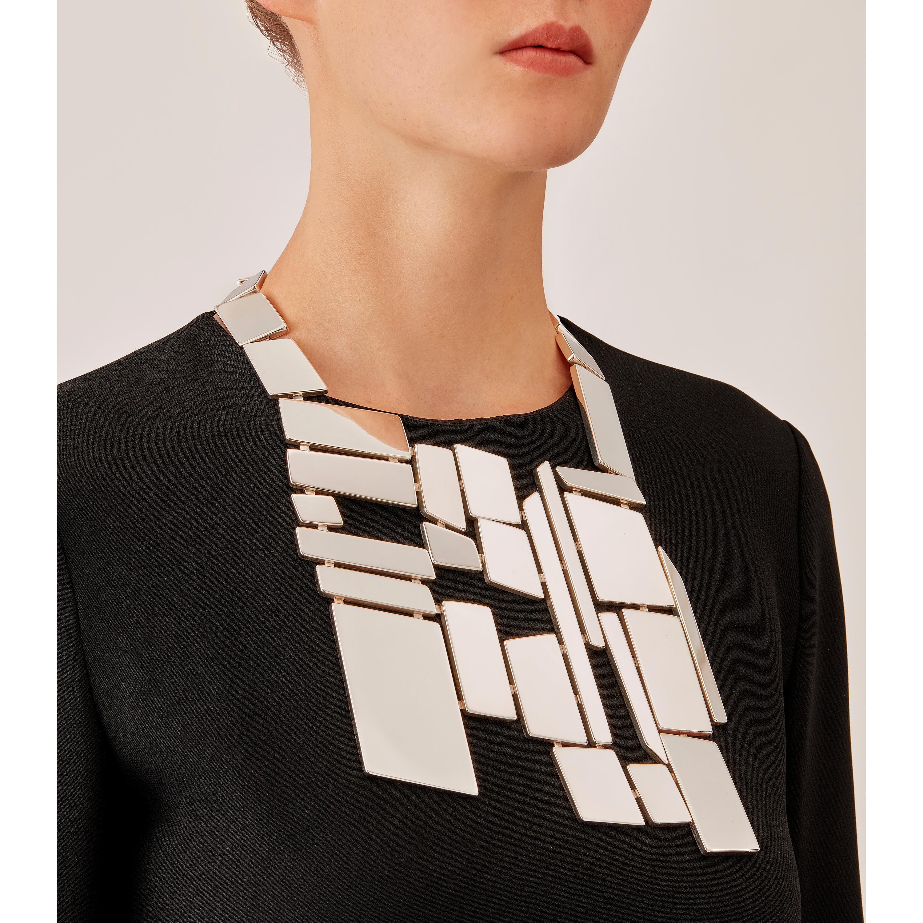 Made by hand in Nathalie Jean's Milan atelier in limited edition, Saphir Absolu Pectoral is a contemporary drop necklace composed of light hollow geometric volumes with rounded edges, in sterling silver. Clever hidden links allow the pieces to drape