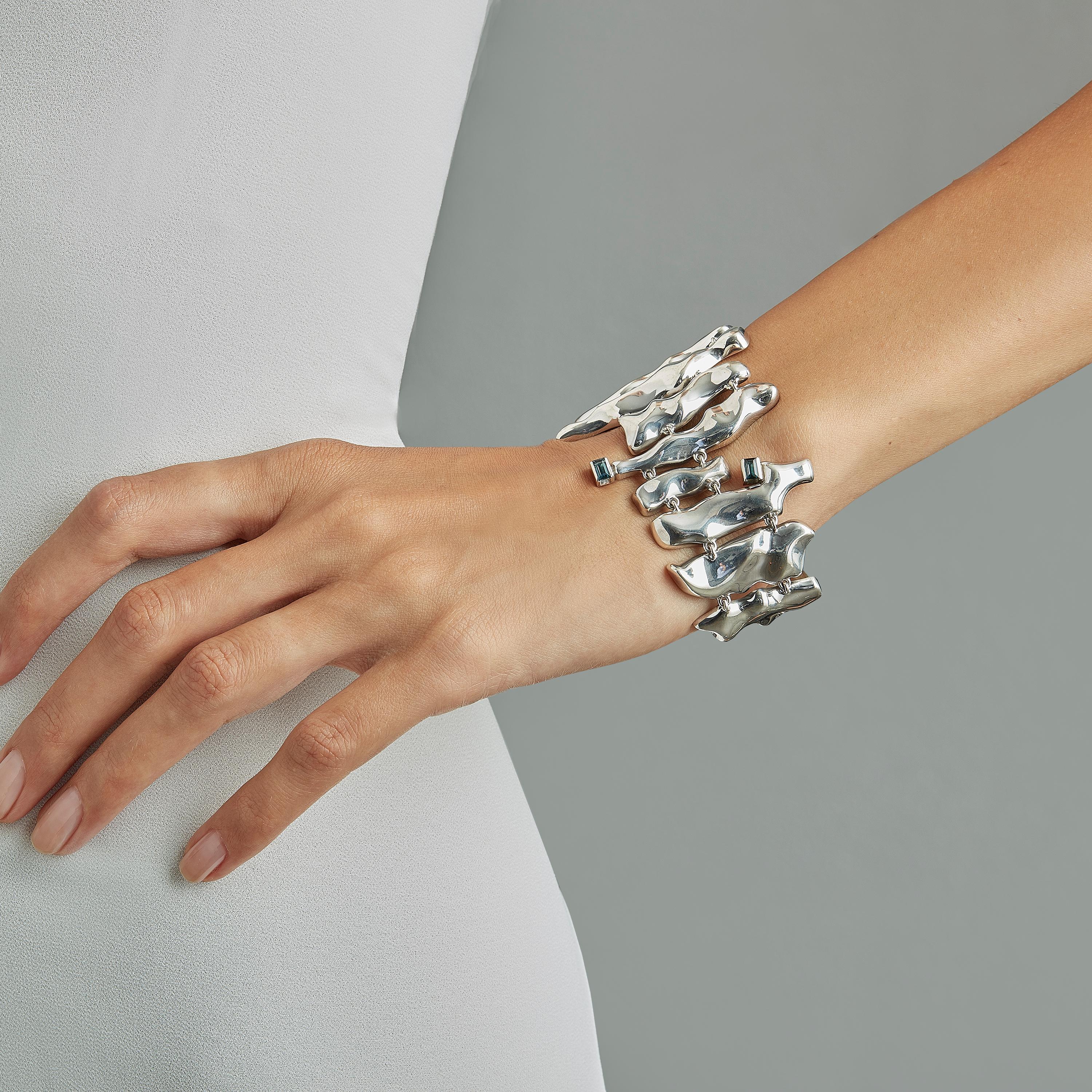 Made by hand in Nathalie Jean's Milan atelier in limited edition, Mercure cuff Bracelet is composed of 16 cleverly articulated elements of varying dimensions wrapping nicely around the wrist. Small, delicate, ebbing sculptures in rhodium plated