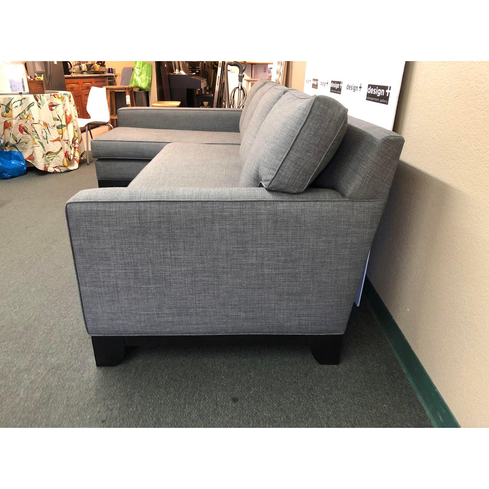 A contemporary two-piece sectional by Nathan Anthony. Simple lines and roomy comfort are the story. Looses back and seats are foam filled cushions. The upholstery is a woven gray and white with self welting.

Measures: Sofa: 81”W x 39”D x
