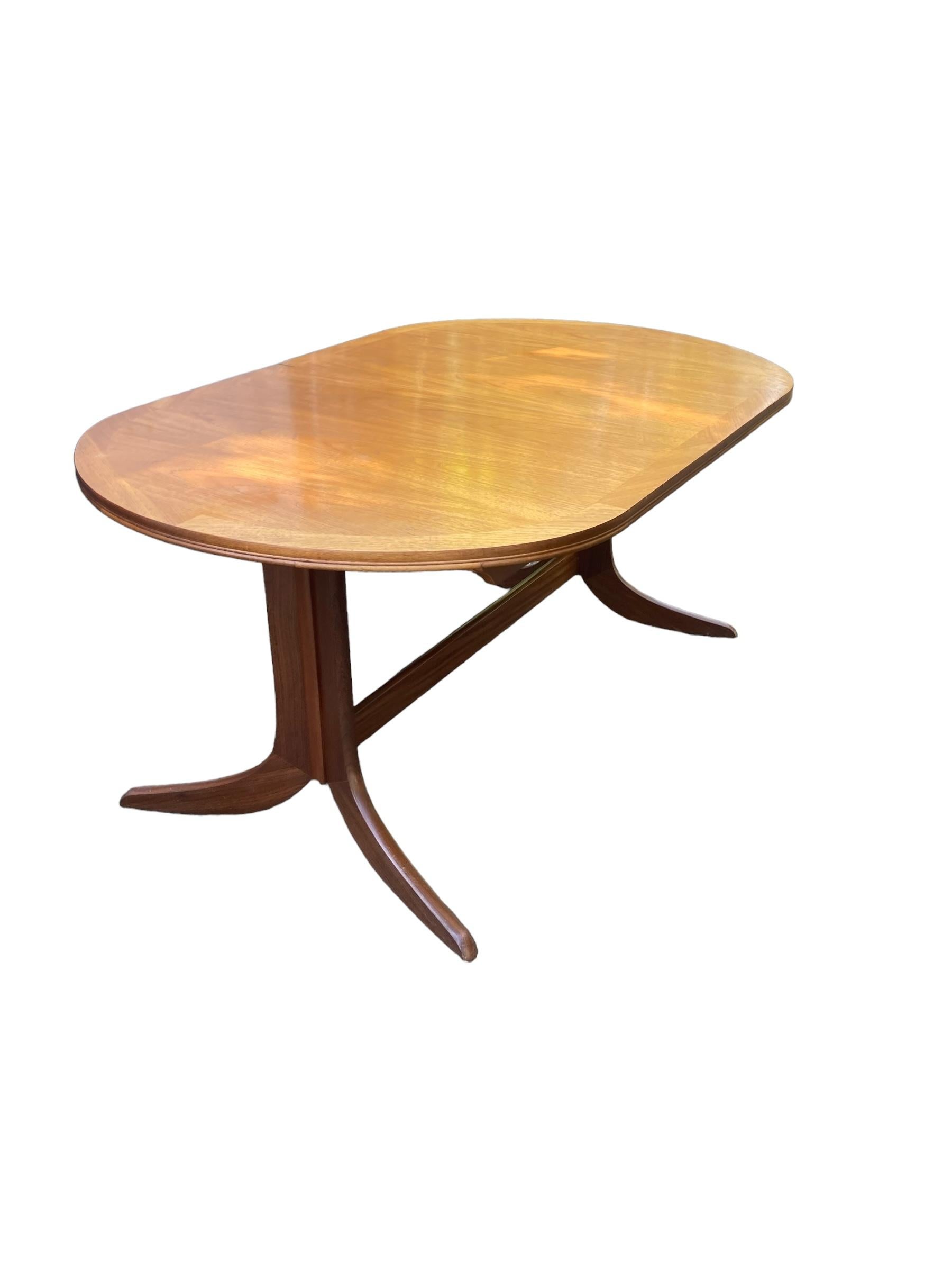 Nathan Extendable Teak Mid Century Dining Table, classic fishtail deaign legs. Great condition. These tables are easily extended with the butterfly design centre piece that pulls out to seat seat to eight people comfortably, then pushes back