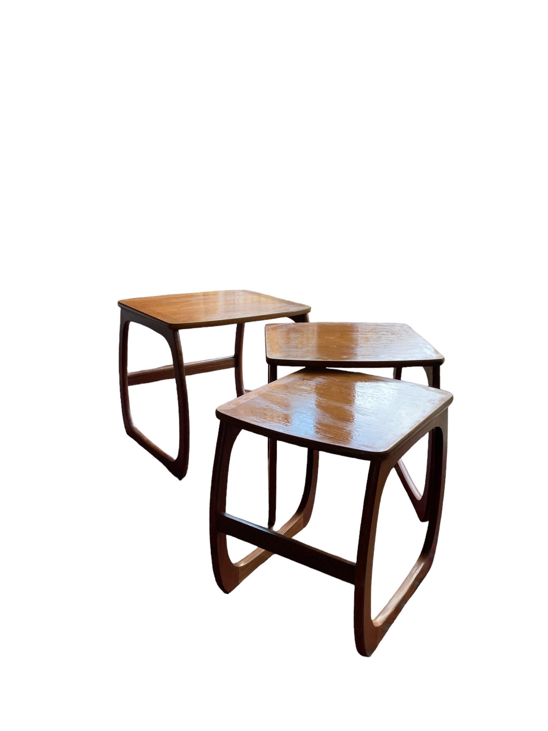 Nathan Nest of Teak Tables, Mid Century Design with elegantly curved legs and a sleek top. Crafted with precision and attention to detail, these tables are the epitome of timeless beauty and functionality. Made from Teak wood, they boast a sturdy