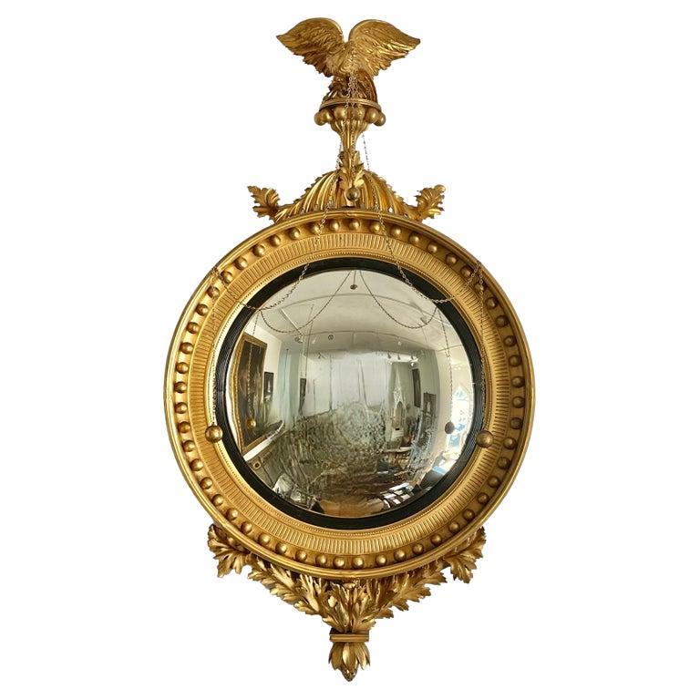 Monumental and historically important Salem Massachusetts giltwood convex mirror. Purchased by Nathaniel Bowditch for his Salem House around 1810-15. Carved and Crafted in Salem. Eagle Mounted with giltwood balls and foliate arms.

Provenance: