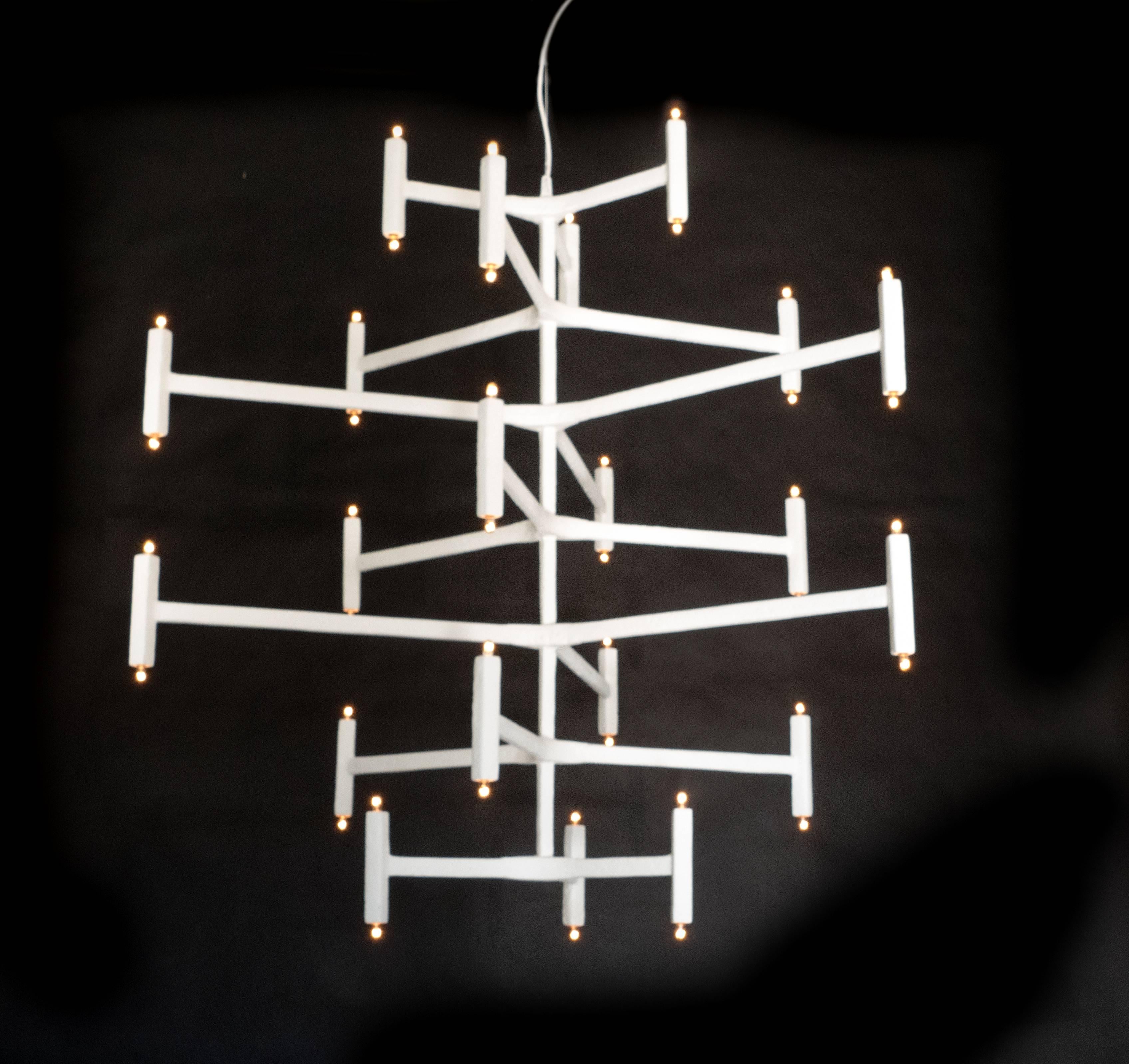The presence of this large-scale chandelier will be the centerpiece of the room as it graciously floats in the space. This seven layered chandelier, a larger version of our Nation chandelier, has a plaster of Paris finish. It is suspended from an