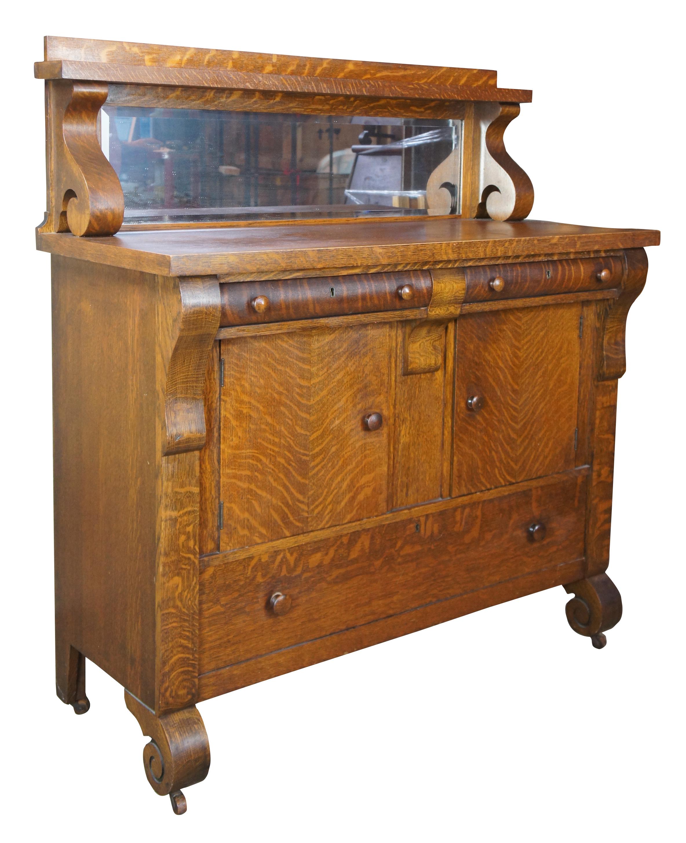 National furniture antique Empire quartersawn oak buffet or sideboard and mirror

Early 20th century buffet or server from National Furniture Company. Made from quartersawn oak with a contoured front featuring 3 drawers and a central cabinet for