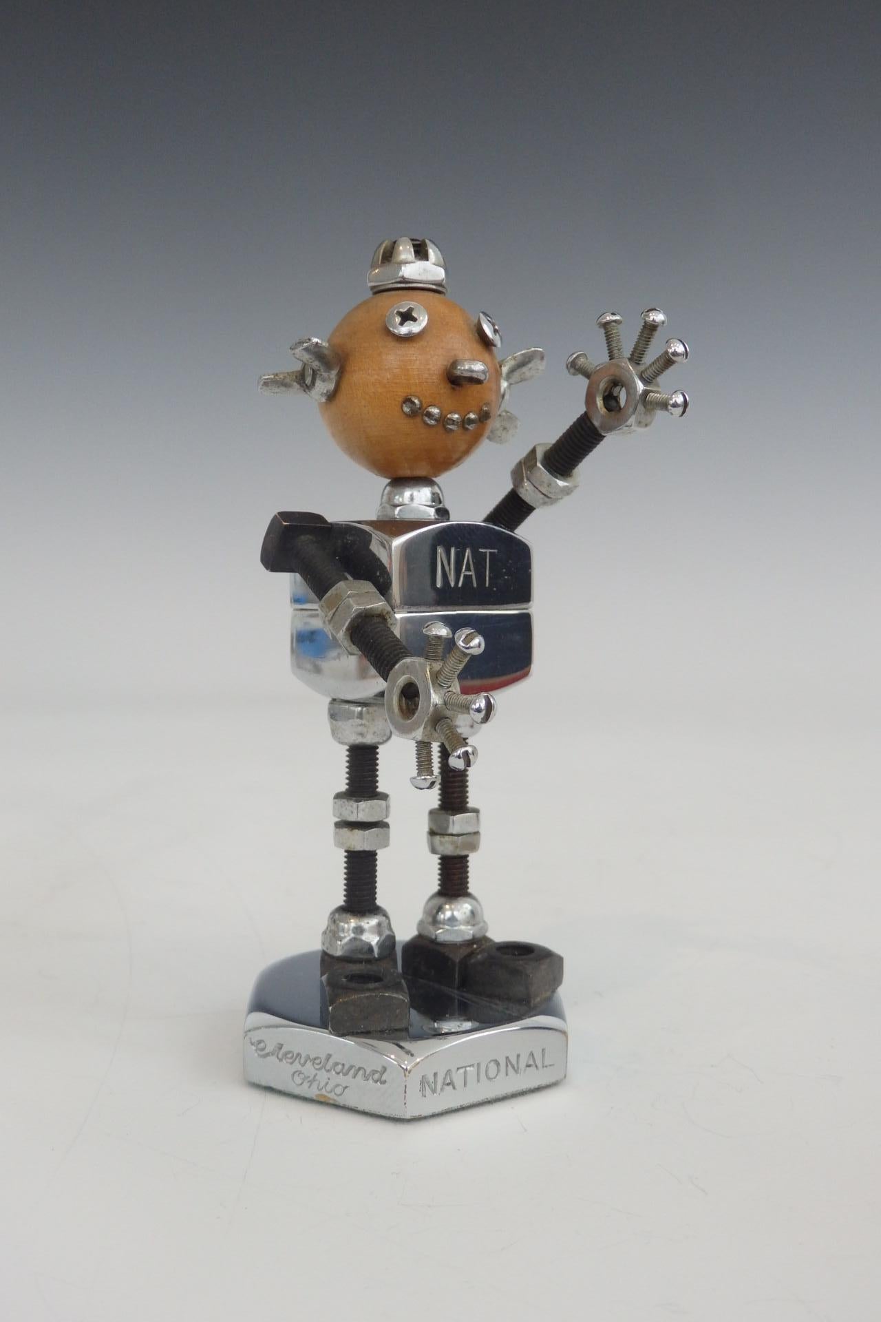 National harder advertising mascot. Made up of chromed nuts and hardware bits. Shown with old hardware box depicting its image. Robot is in excellent condition. Box shows wear.