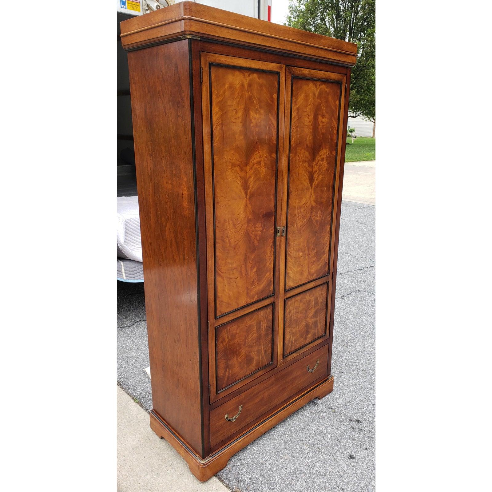 This beautiful National Mount Airy Furniture vintage armoire is made out of solid walnut, flame walnut and satinwood inlays. This armoire features a bottom drawers with sleek drop down pulls. Top part has 2 shelves and multiples drawers and cubbies.