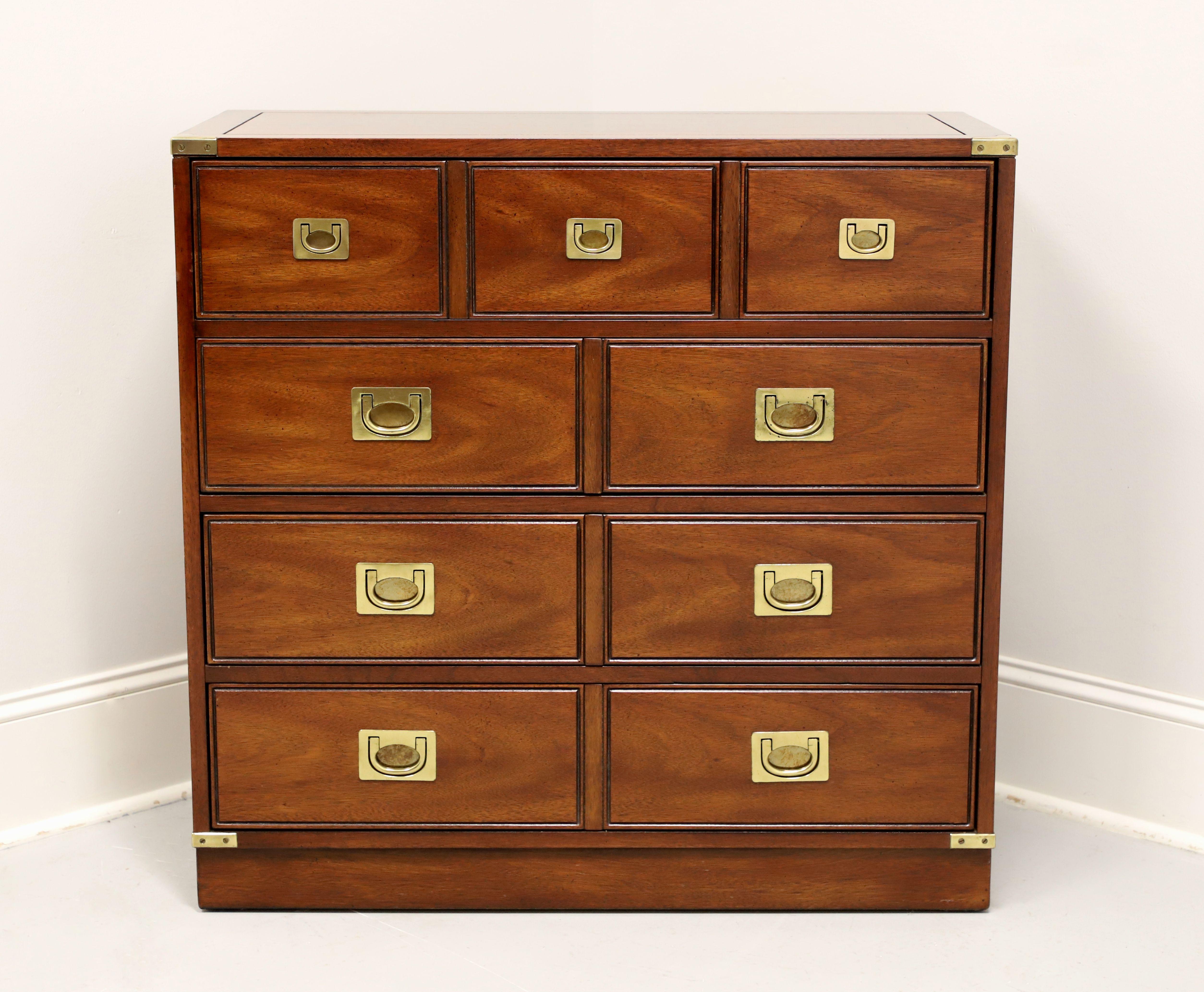 A campaign style bachelor chest by National Mount Airy Furniture, from their Lancer II Collection. Mahogany with banded flat edge top, brass hardware & accents, and a solid base. Features four drawers of dovetail construction with the faux look of