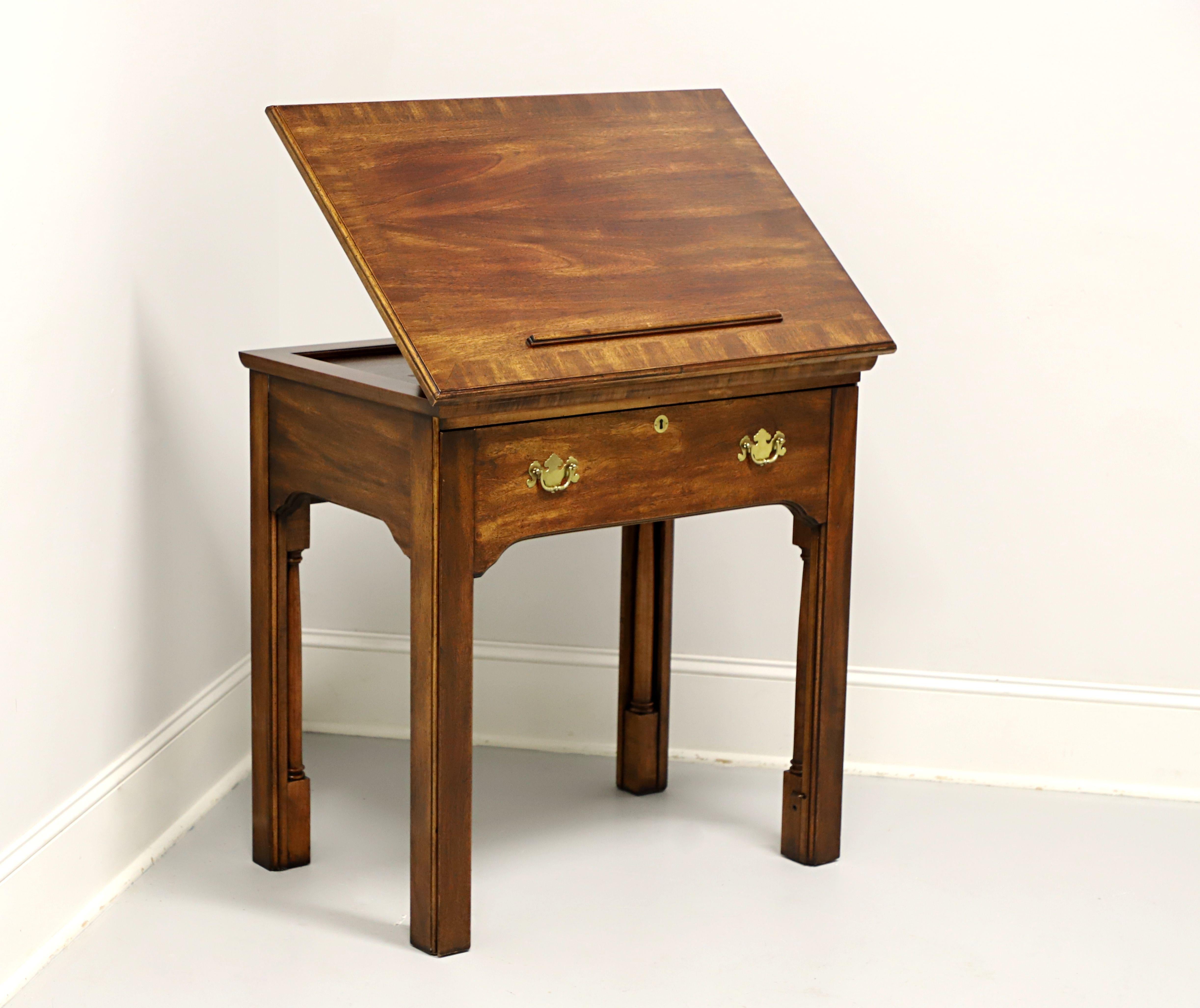 An adaptation of the Colonial period Thomas Jefferson Tall Adaptable Desk currently at Monticello, by National Mount Airy Furniture. Their version is similar, although shorter, to the original desk. Solid mahogany with brass hardware,  faux keyhole