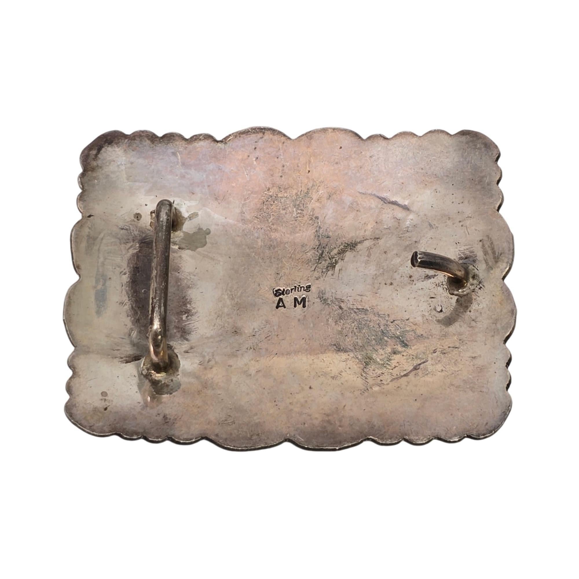 Sterling silver belt buckle by Native American Navajo artisan Alfred Martinez.

Beautifully ornate sterling silver belt buckle featuring a sunburst design with stamped accents.

Weighs approx 33.6g, 21.6dwt

Measures approx 2 5/8