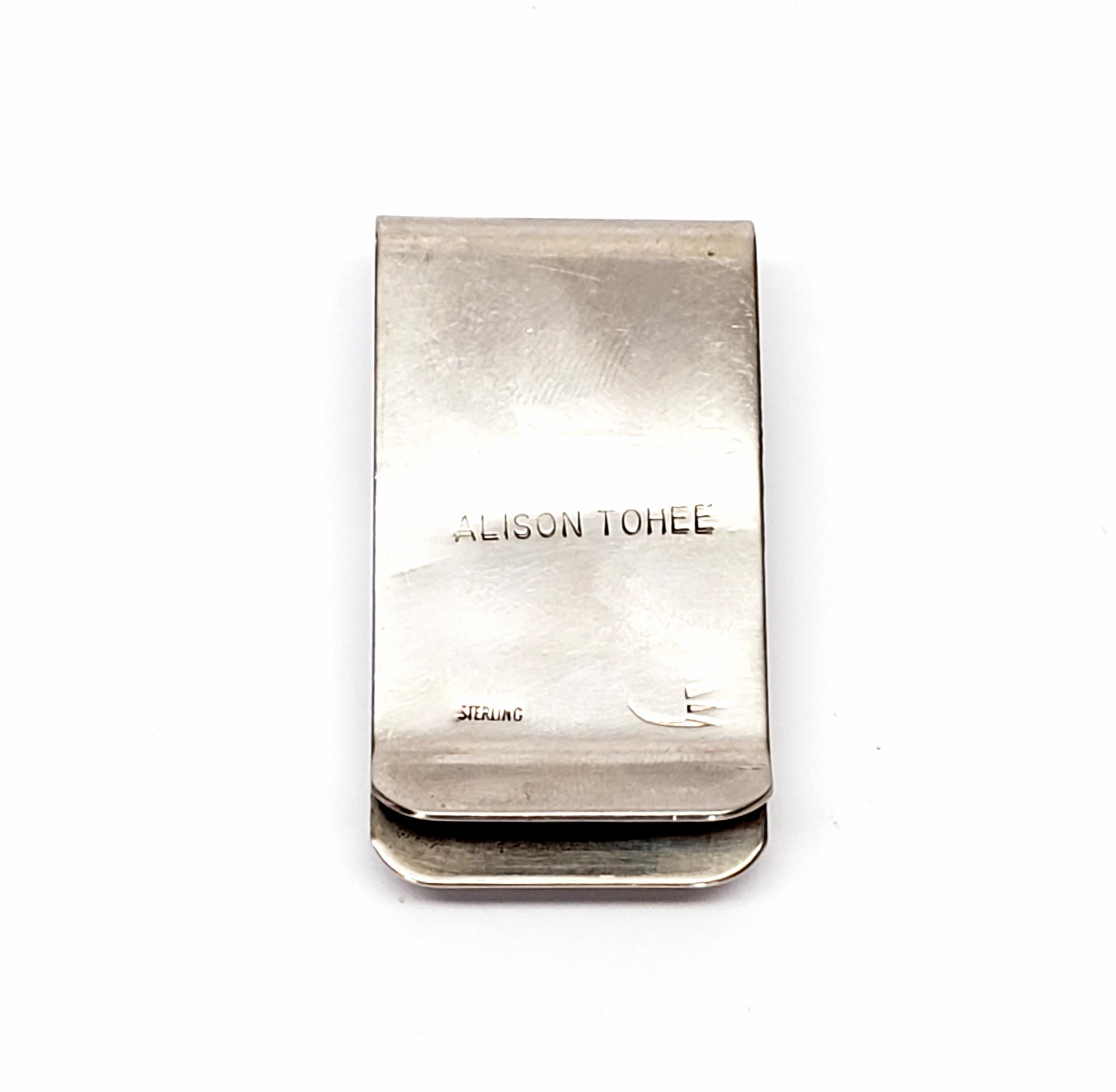 Sterling silver and turquoise money clip by Native American Navajo artisan Alison Tohee.

Simple and timeless design features a saw tooth bezel set square turquoise stone.

Measures approx 1 3/4