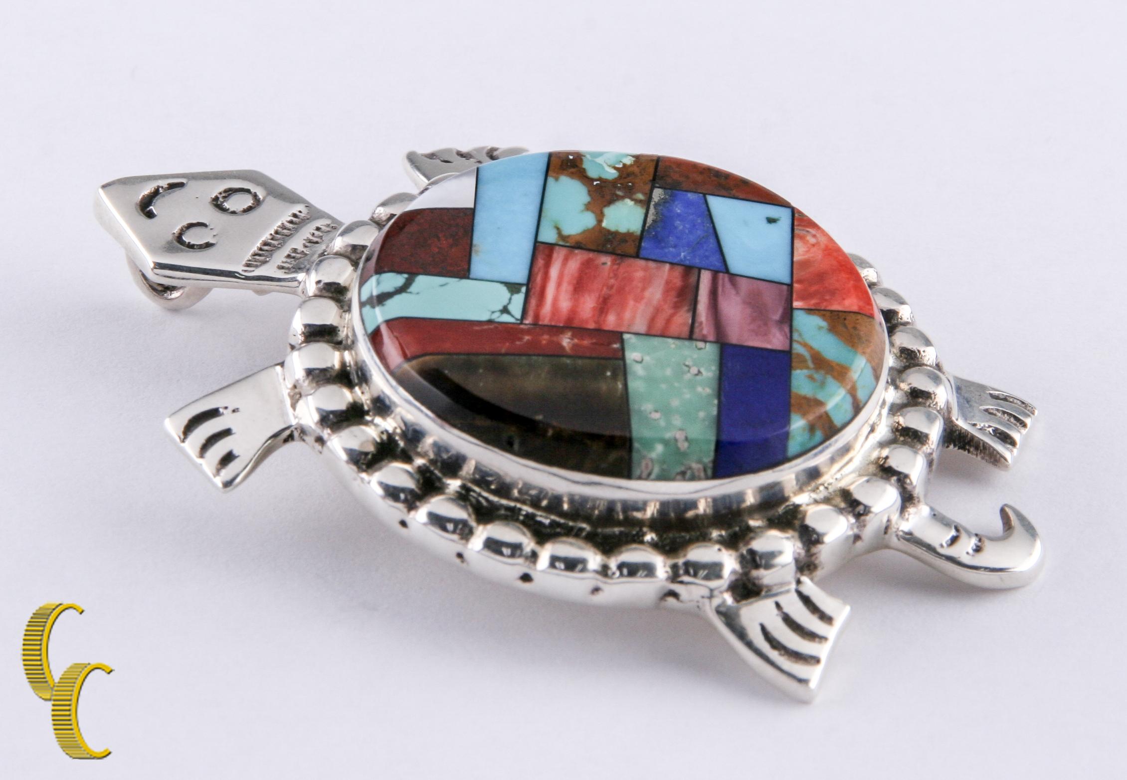 Gorgeous sterling silver turtle pendant/brooch (back has a bail and a pin).
Features a gorgeous hand-crafted inlay shell.
Includes a certificate of authenticity.
Inlaid with spiny oyster, turquoise, lapis, coral, mother-of-pearl and petrified
