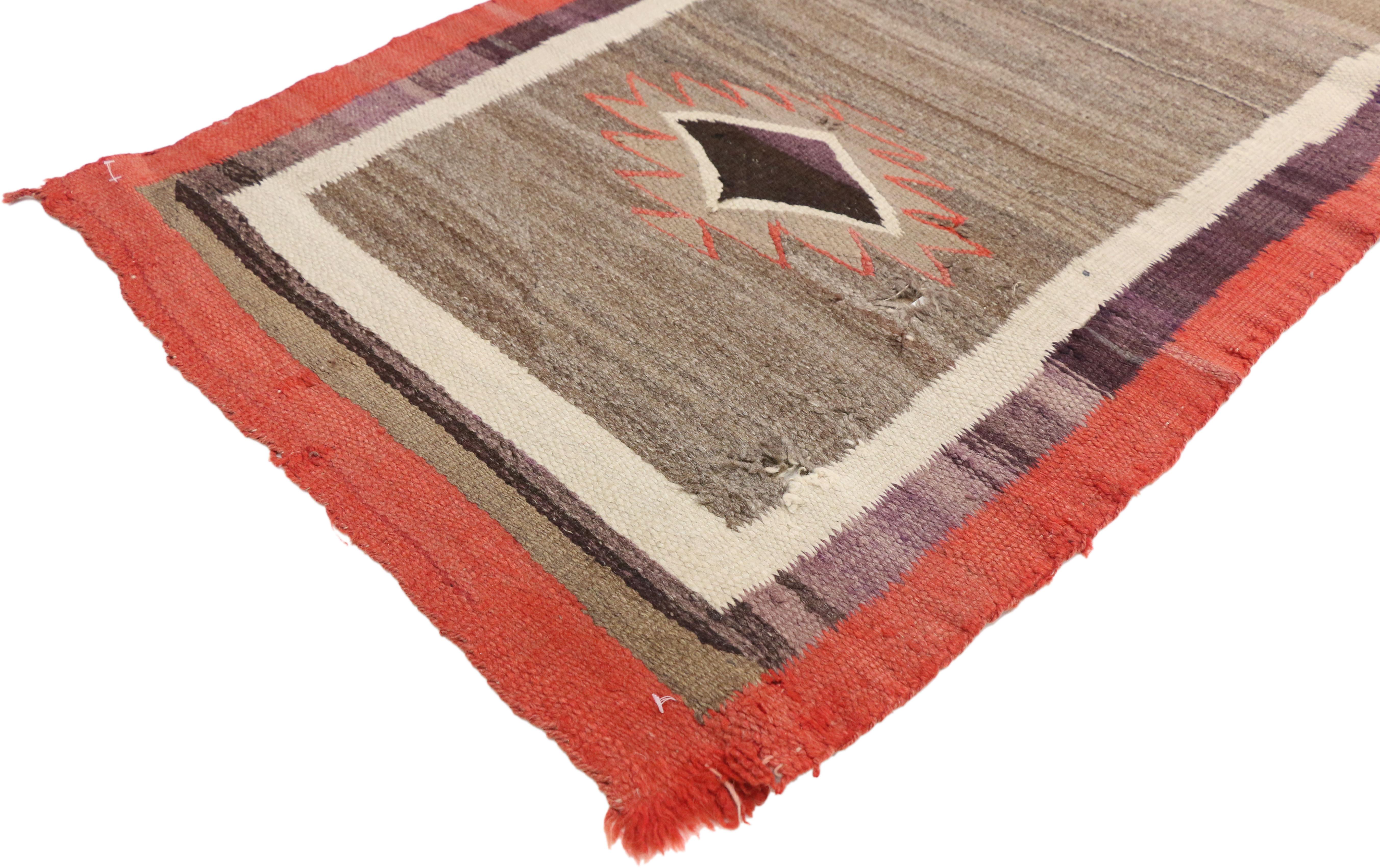 77145 Native American Antique Indian Navajo Kilim rug with Southwest style. Captivating and emanating Navajo vibes and Southwest style, this handwoven wool antique Native American Indian Kilim rug features two diamond amulets with serrated edges in