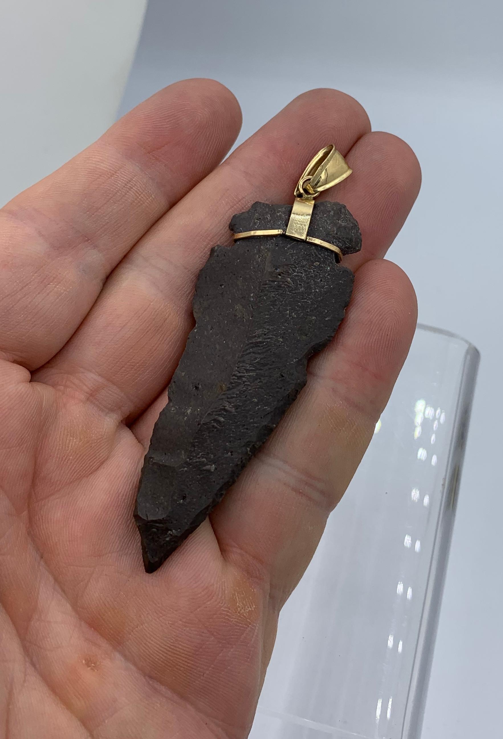 We love the combination of ancient archeology with fine jewelry!  Here we have a gorgeous Native American Arrowhead set in 14 Karat Gold in this dramatic Pendant.   The dramatic arrowhead is 3 inches long and 1 1/8 inches wide.  One side of the