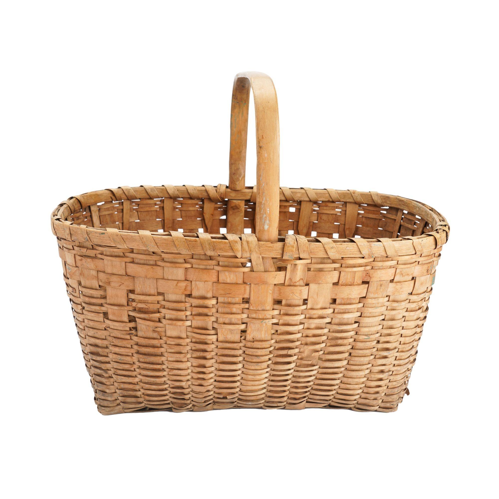 Native American woven ash splint basket with carved & bent loop handle flattened at the apex. The rim of the basket is comprised of two carved & bent ash splints with ash stays, woven from either side of the rim making a woven splint base for the