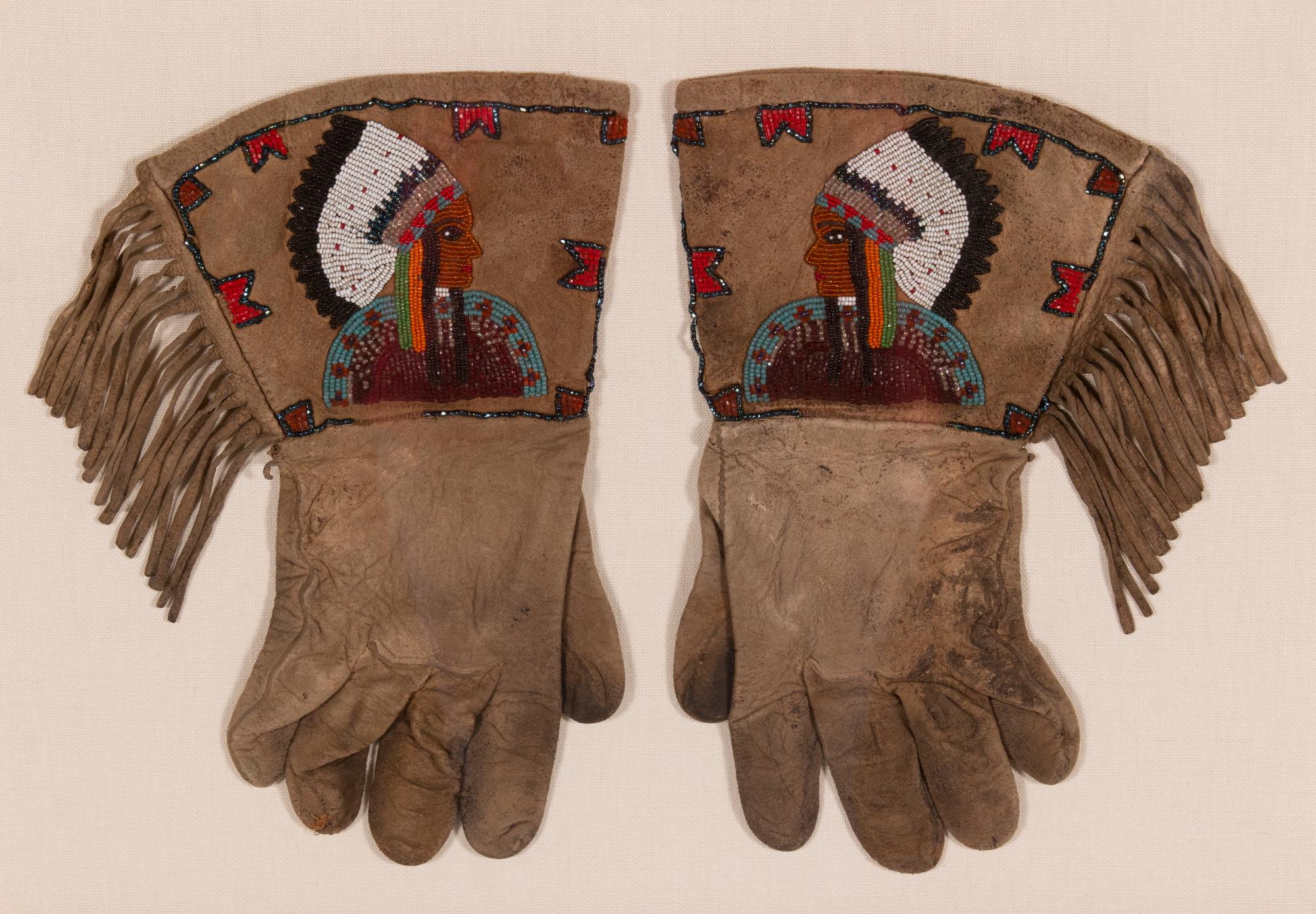 Native American beadwork gauntlets with Indian Chiefs in feathered headdresses, probably souix, Ca 1880-90

Native American beadwork gauntlets with beautiful graphics and endearing wear. Made of doeskin, the imagery includes colorfully dressed