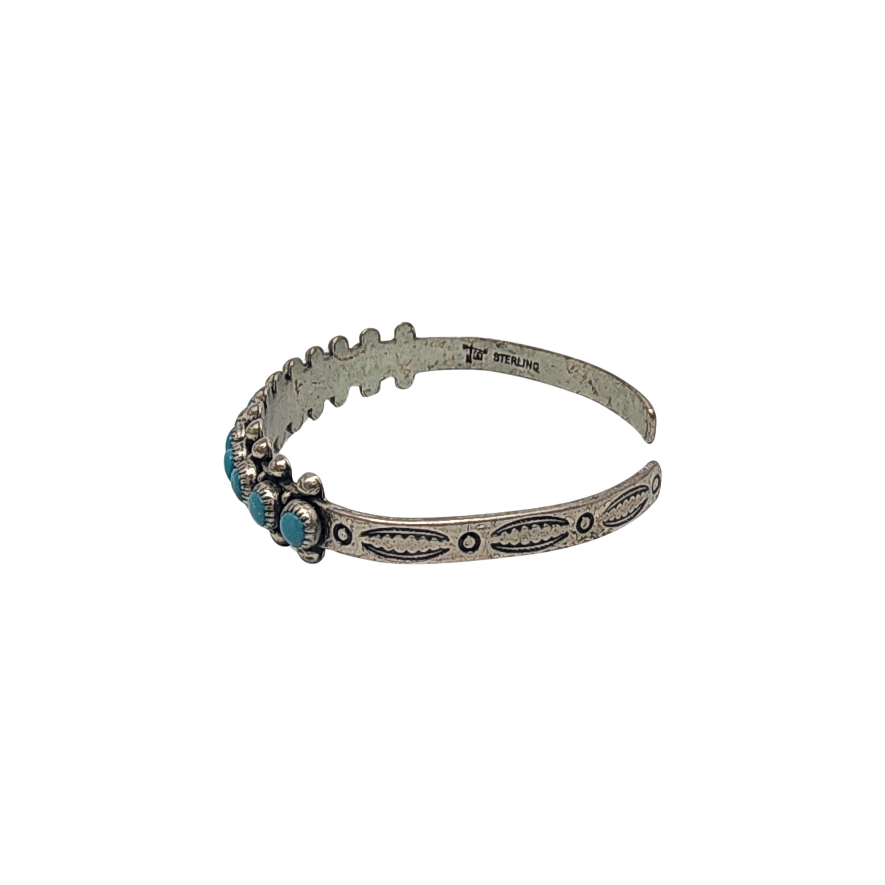 Vintage sterling silver and turquoise cuff bracelet from Bell Trading Post, circa 1961-72

This bracelet features a snake eye design of round blue turquoise stones. The Bell Trading post was located along Route 66 and sold locally made Native