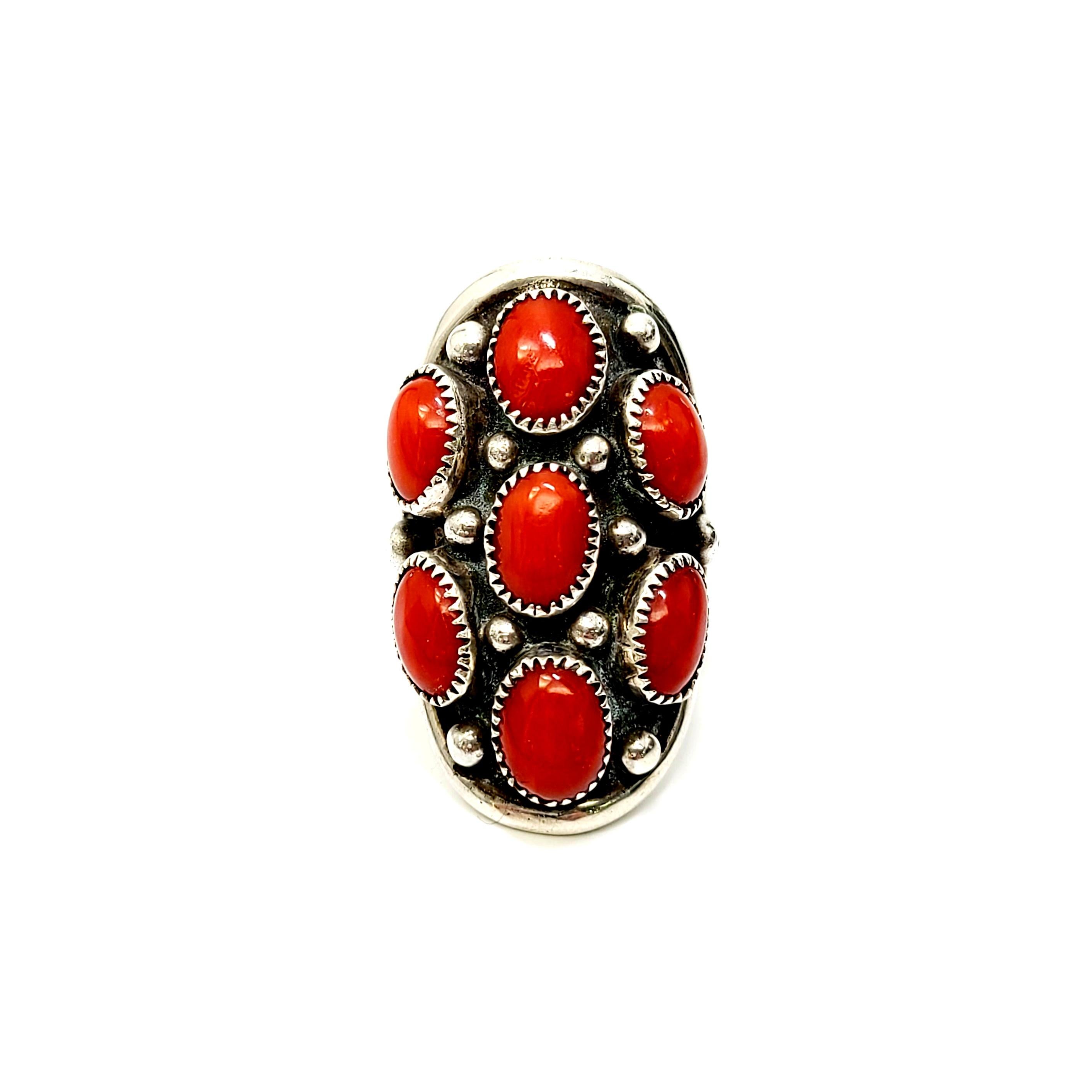 Sterling silver and red coral ring by Native American Navajo artisan Benny Touchine.

Size 5.75

Handmade by well-known Navajo artisan circa 1940s-50s. This oblong design features oval shaped coral stones in saw tooth bezels.

Measures approx 1 3/8