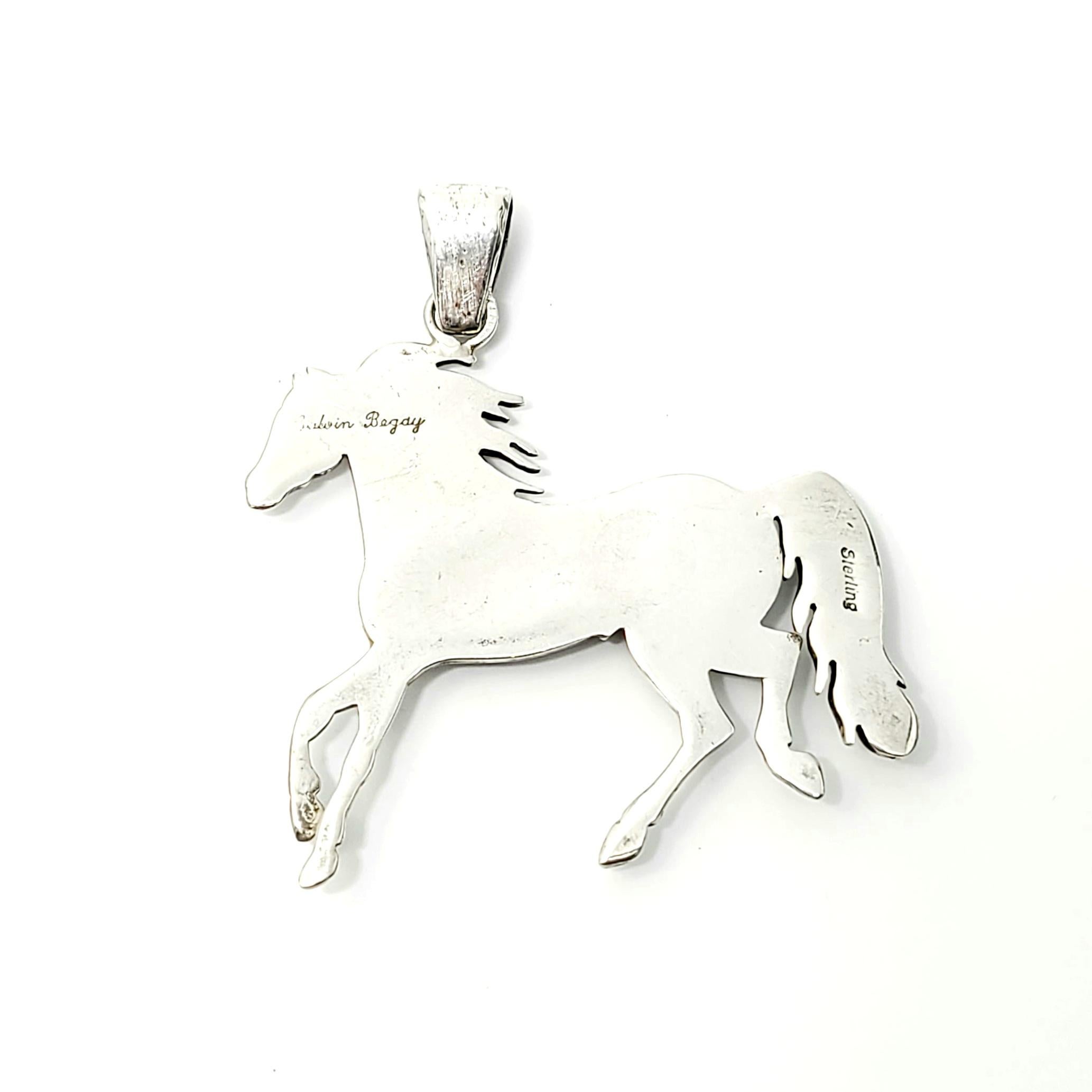 Sterling silver and inlay mosaic horse pendant by Native American artisan Calvin Begay.

Calvin Begay has been a jewelry designer and master craftsman for 20+ years, using traditional Navajo inlay techniques that reflect his heritage. His pieces are