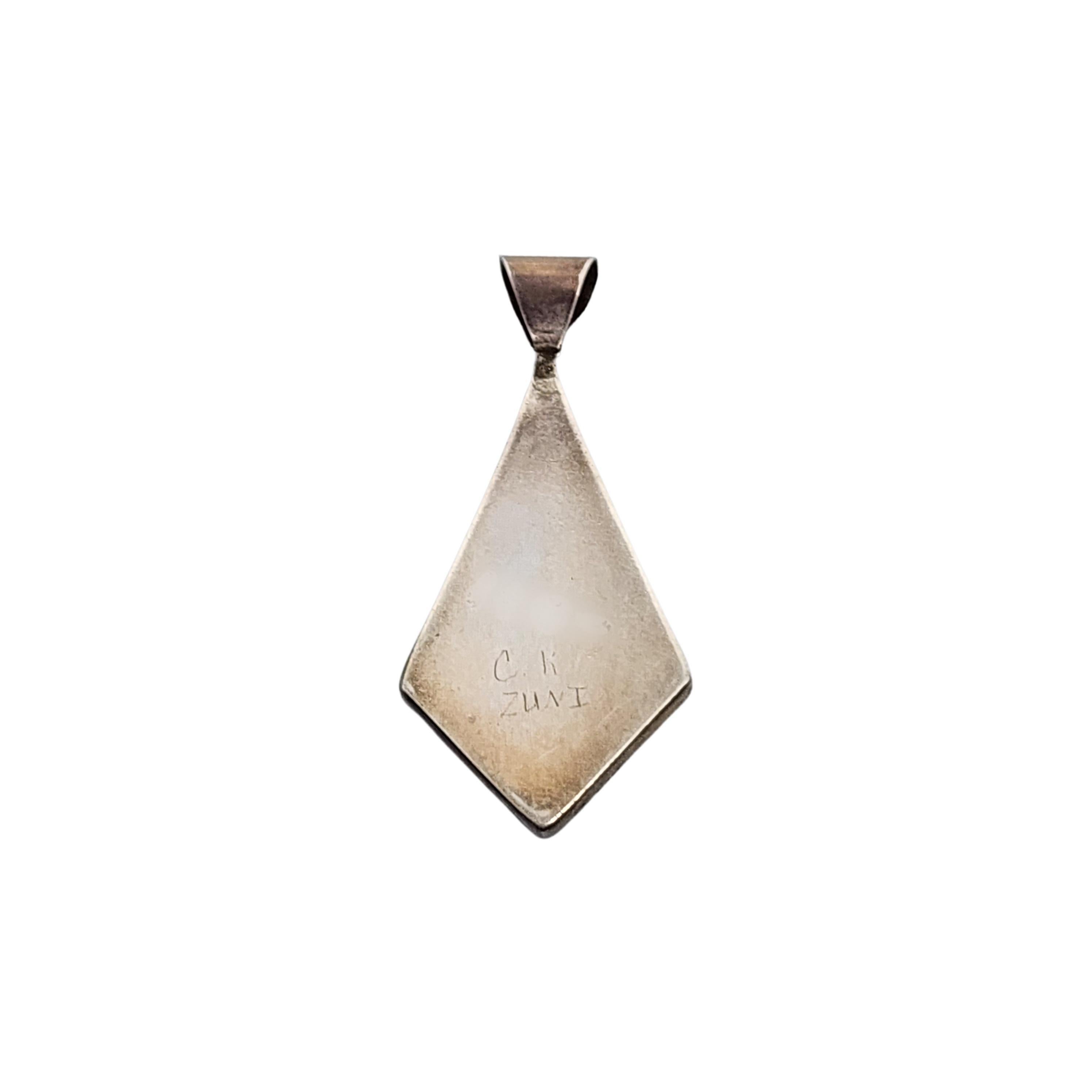 Sterling silver multi stone inlay pendant by Native American Zuni artisan, CK.

Beautiful inlay stone design appear to be mother of pearl, turquoise, onyx and coral, bezel set in a diamond shaped pendant with a large bale.

Measures approx 1 9/16
