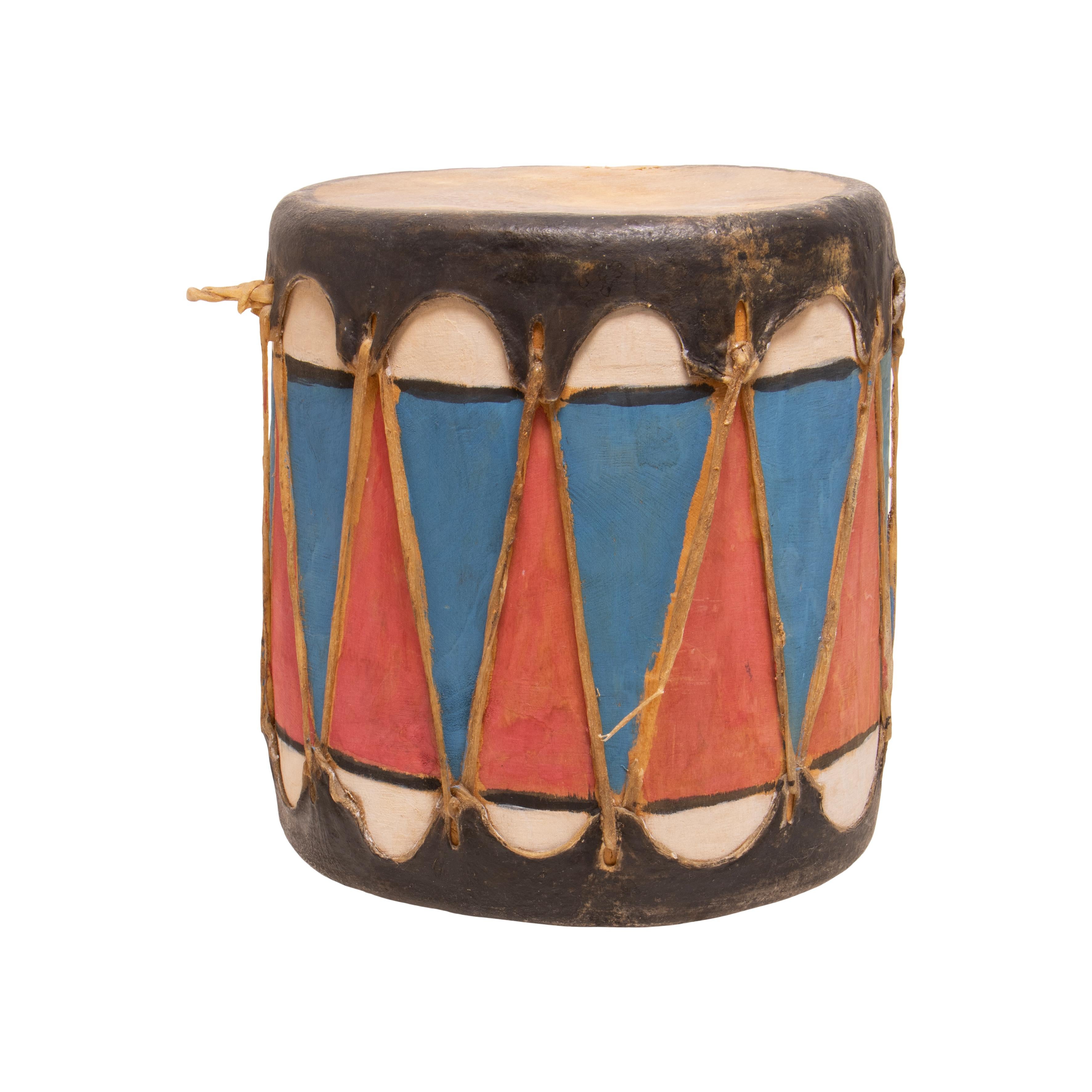 Native American Cochiti drum with sides painted in red, white and blue with black stripes. Made of wood and hide. 

Period: Early 20th century

Origin: Southwest, Cochiti

Size: 10
