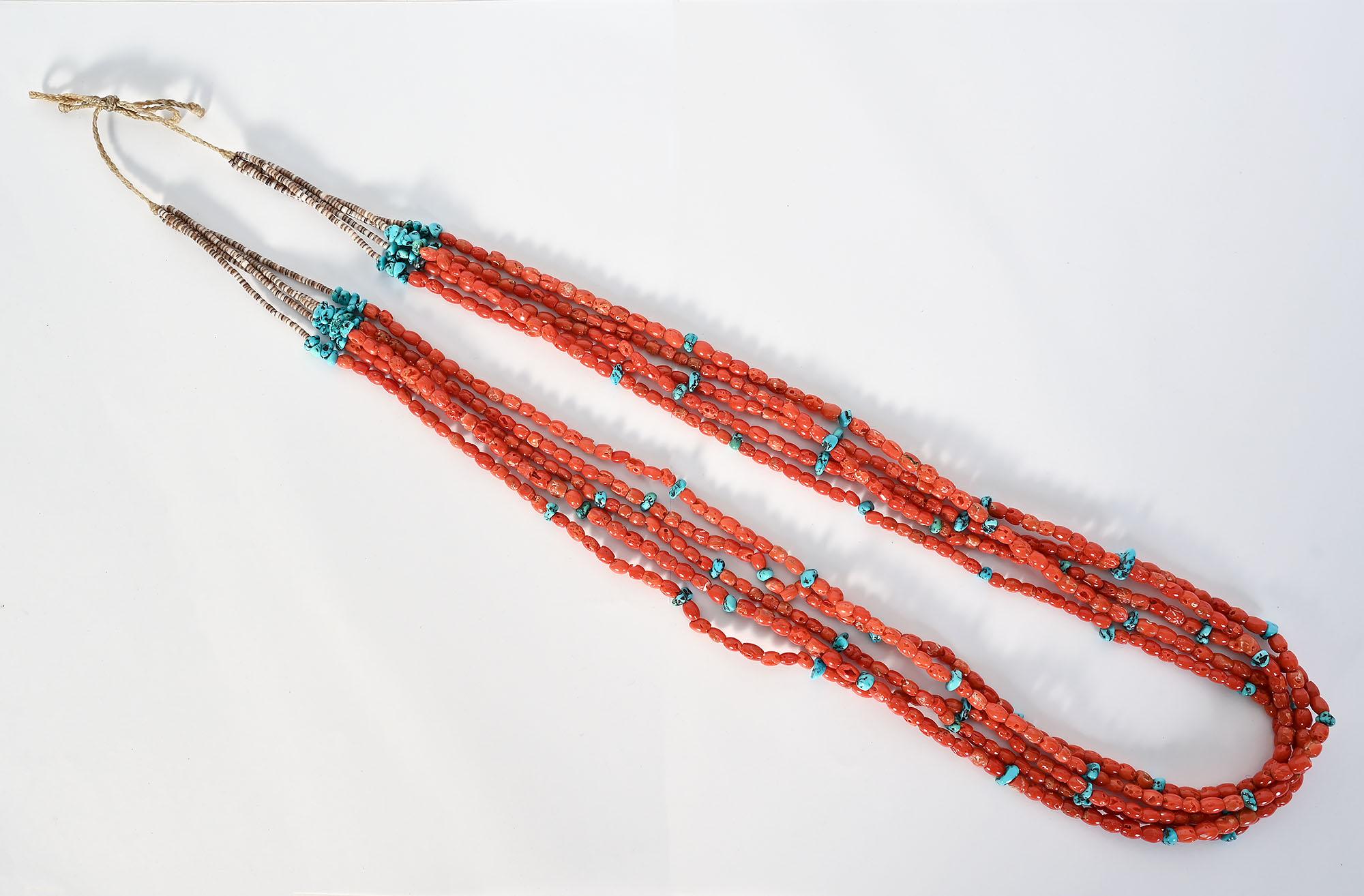 Five strand Native  American (probably Navajo) coral necklace interspersed with turquoise. The coral consists of oval shaped beads and the turquoise beads are irregular in shape. The necklace is 33 1/2 inches long. The 2 1/2 inches closest to the
