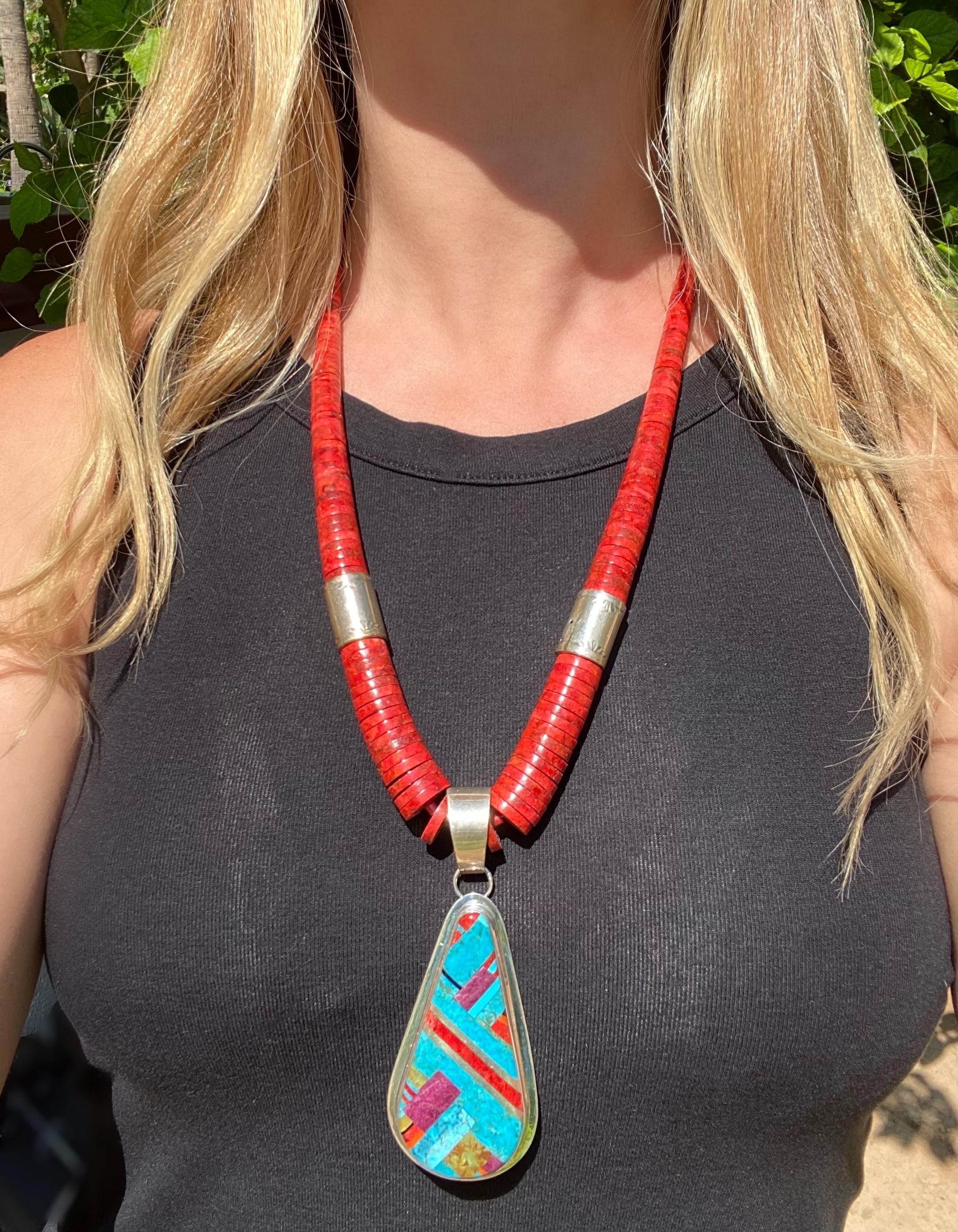 Highly desirable Native American Navajo Coral Disc Necklace enhanced with Sterling Silver Tubular Beads; suspending an Inlay Coral, Turquoise, Spiny Oyster and MOP Sterling Silver Hand crafted Pendant. Necklace measures approx. 25